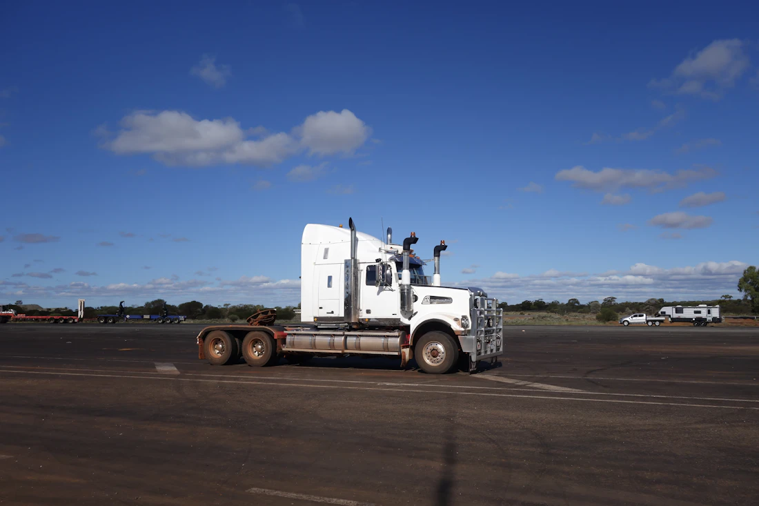 White semi-truck under a blue sky