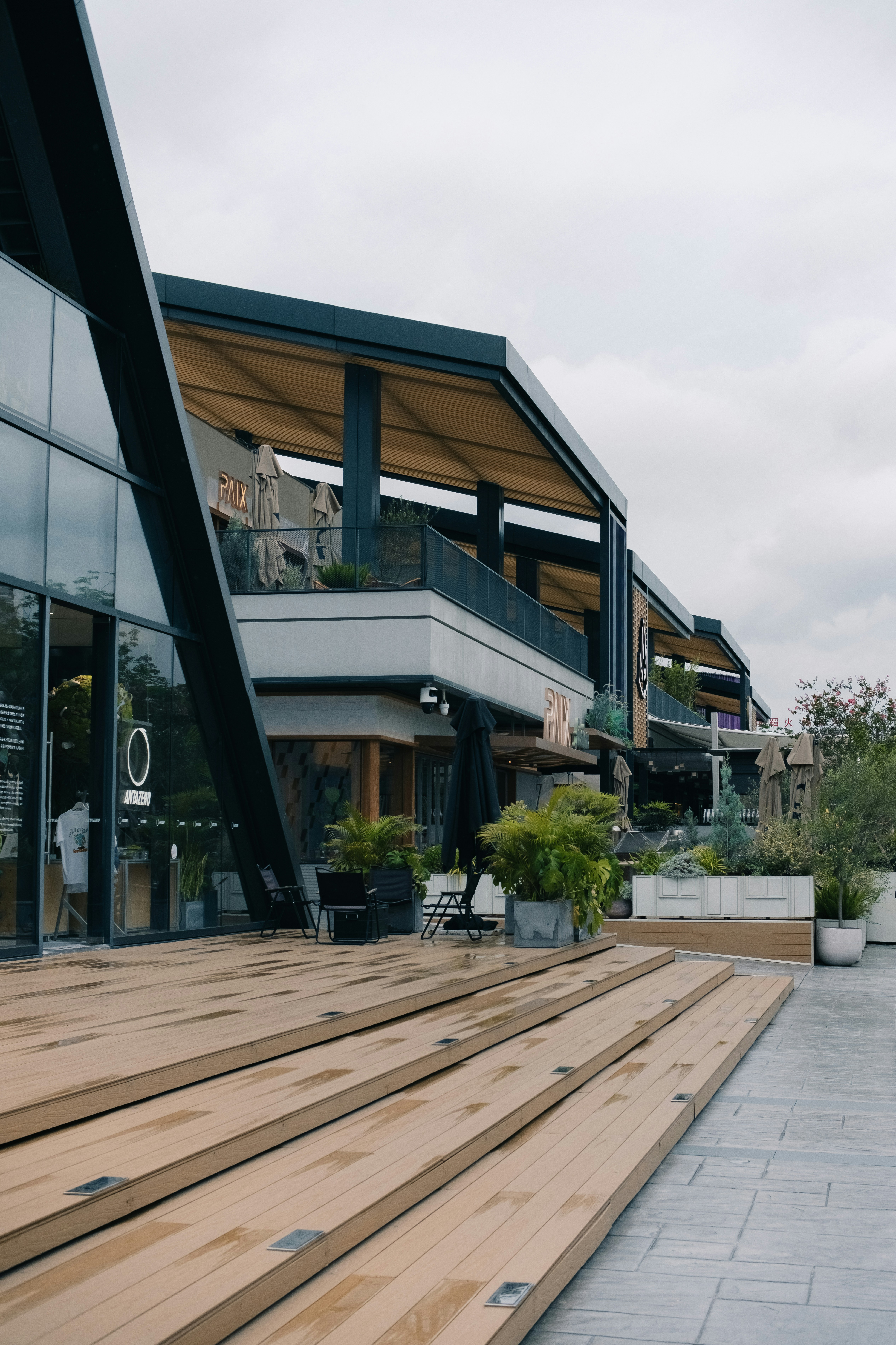 Modern building with wooden steps and outdoor seating.