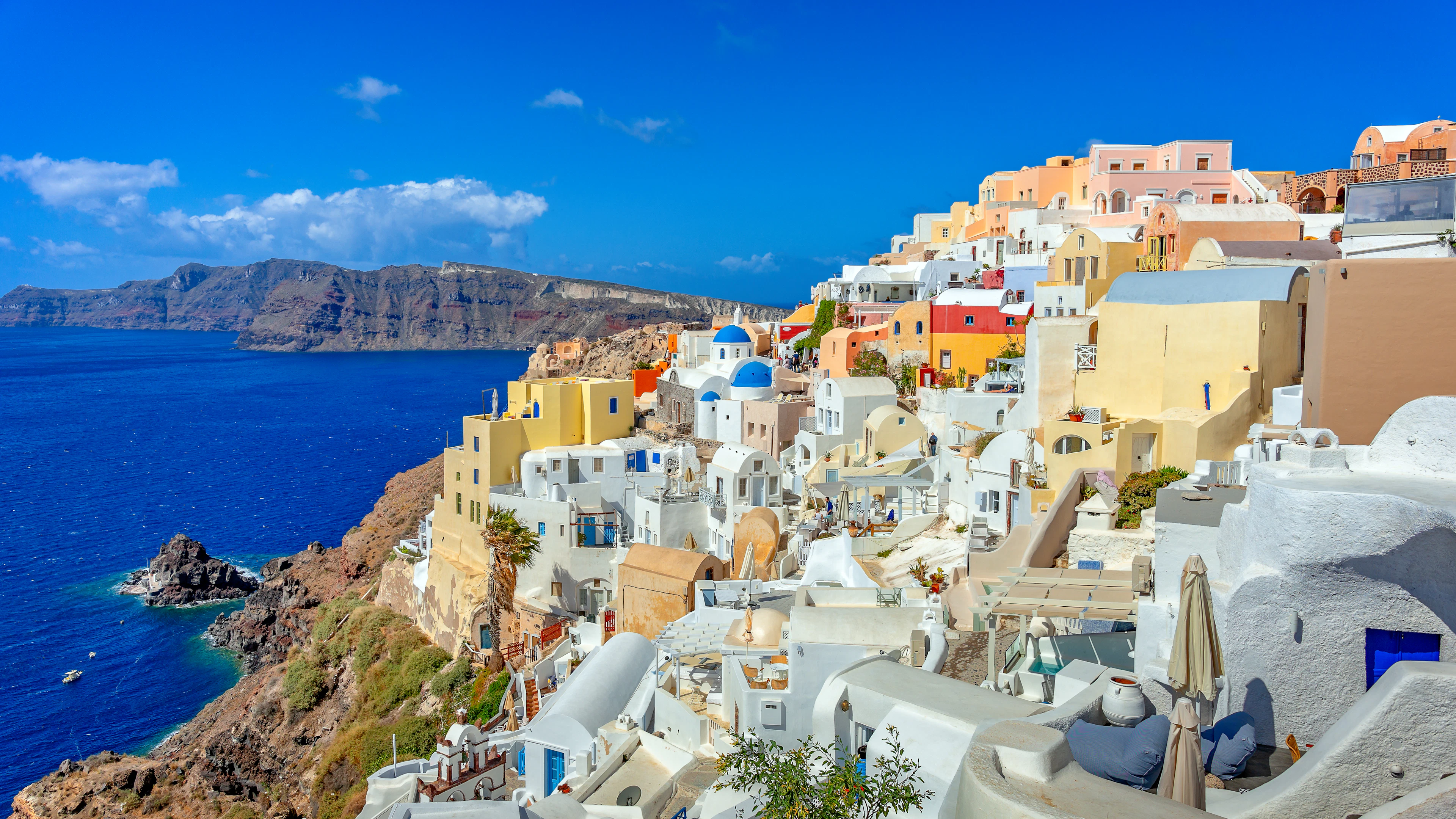 The whitewashed houses and blue-domed churches of Santorini above the Aegean Sea