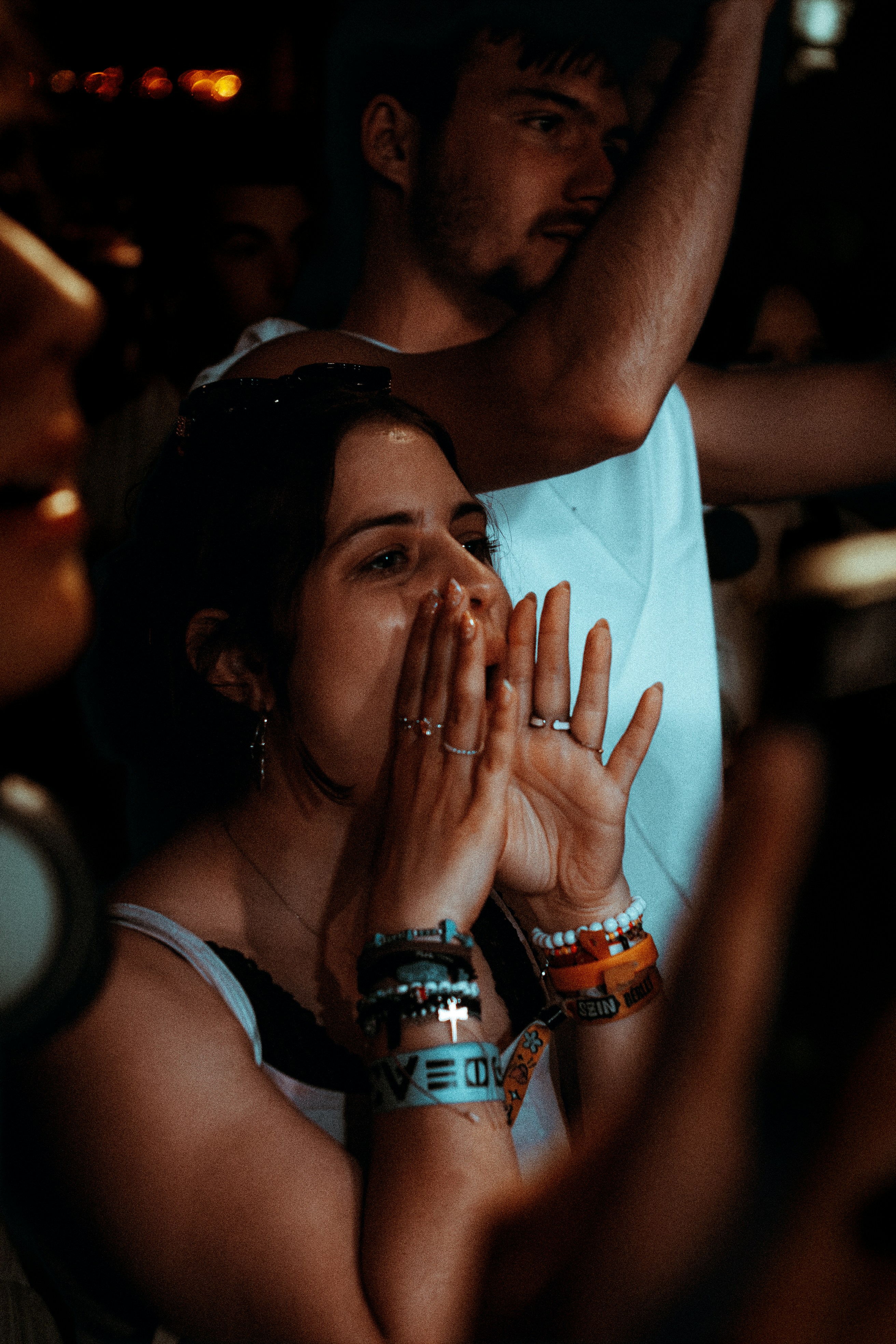 Young woman with cupped hands calling out in a crowd