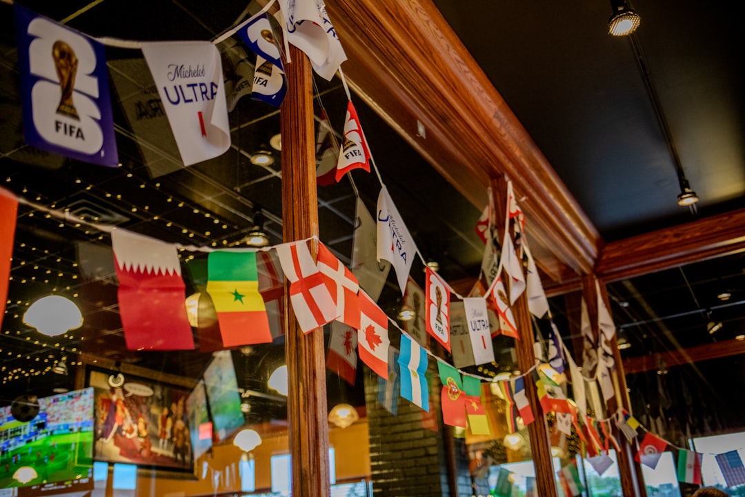 Various international flags and banners hanging in an interior.
