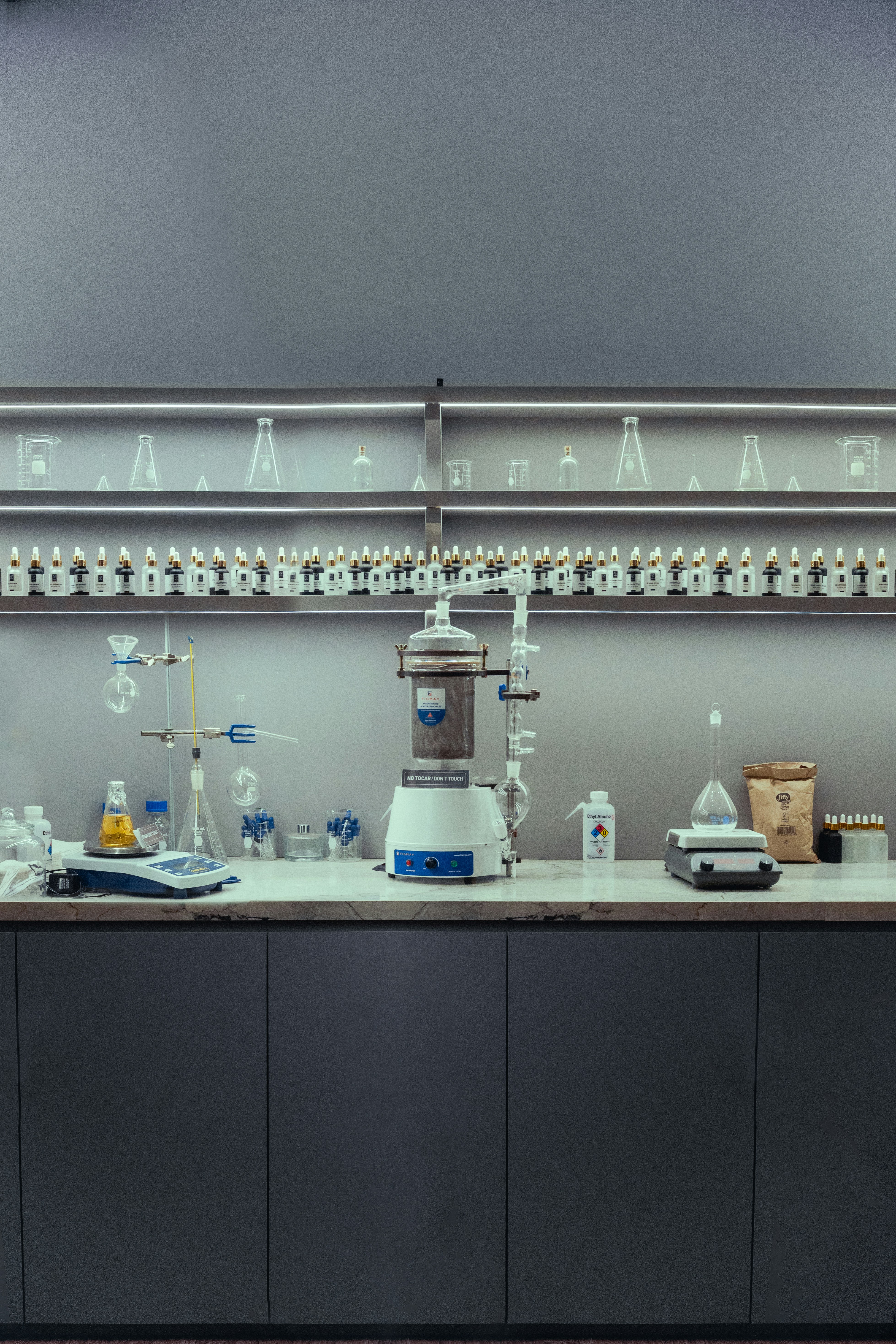 A clean laboratory bench with scientific equipment and glassware.