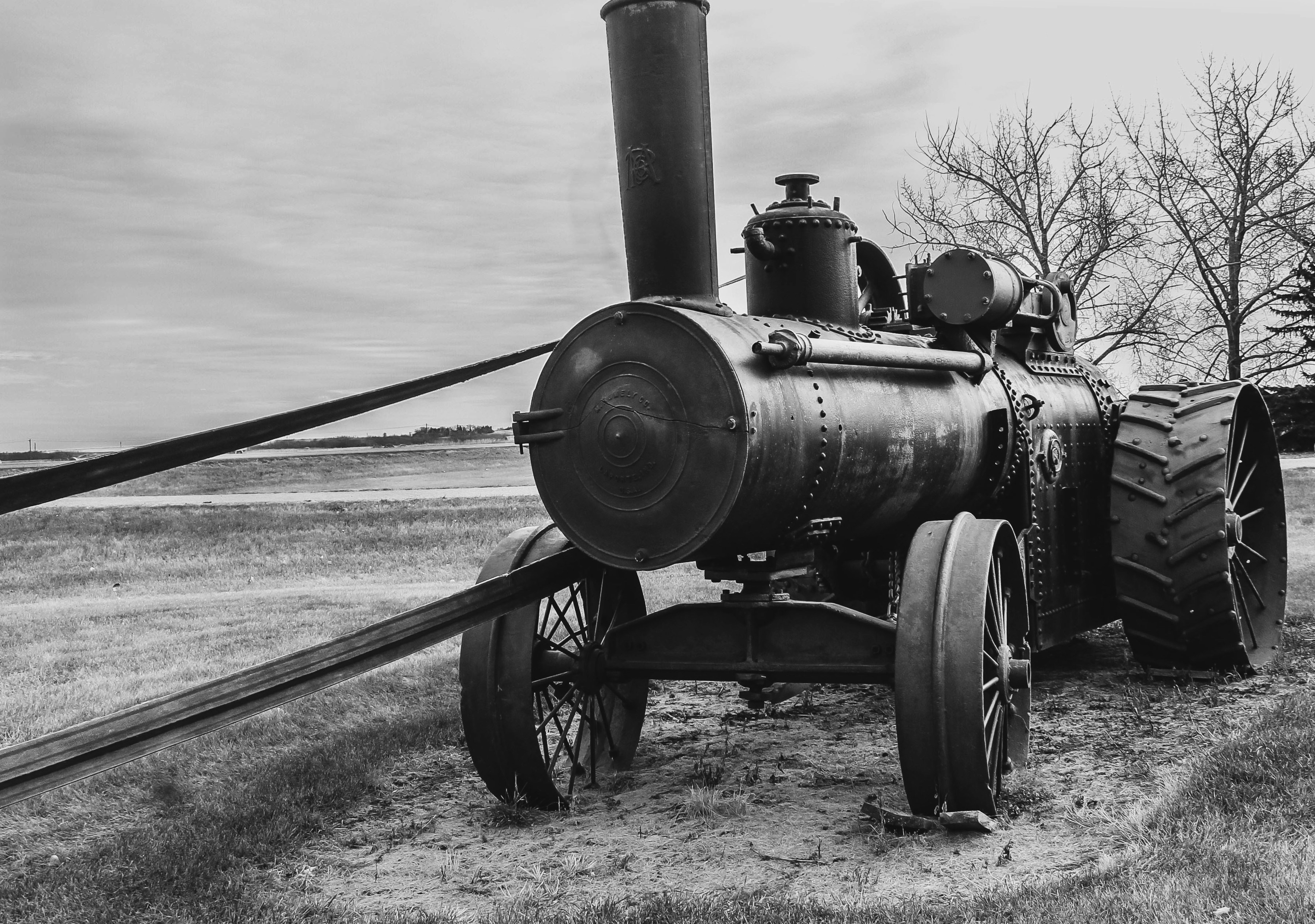 Technology A Striking Black And White Photograph Of A Vintage Steam Traction Engine Displayed Near Vegreville, Alberta. With Its Massive Steel Wheels, Towering Smokestack, And Timeless Industrial Design, This Historic Machine Reflects Alberta's Rich Agric