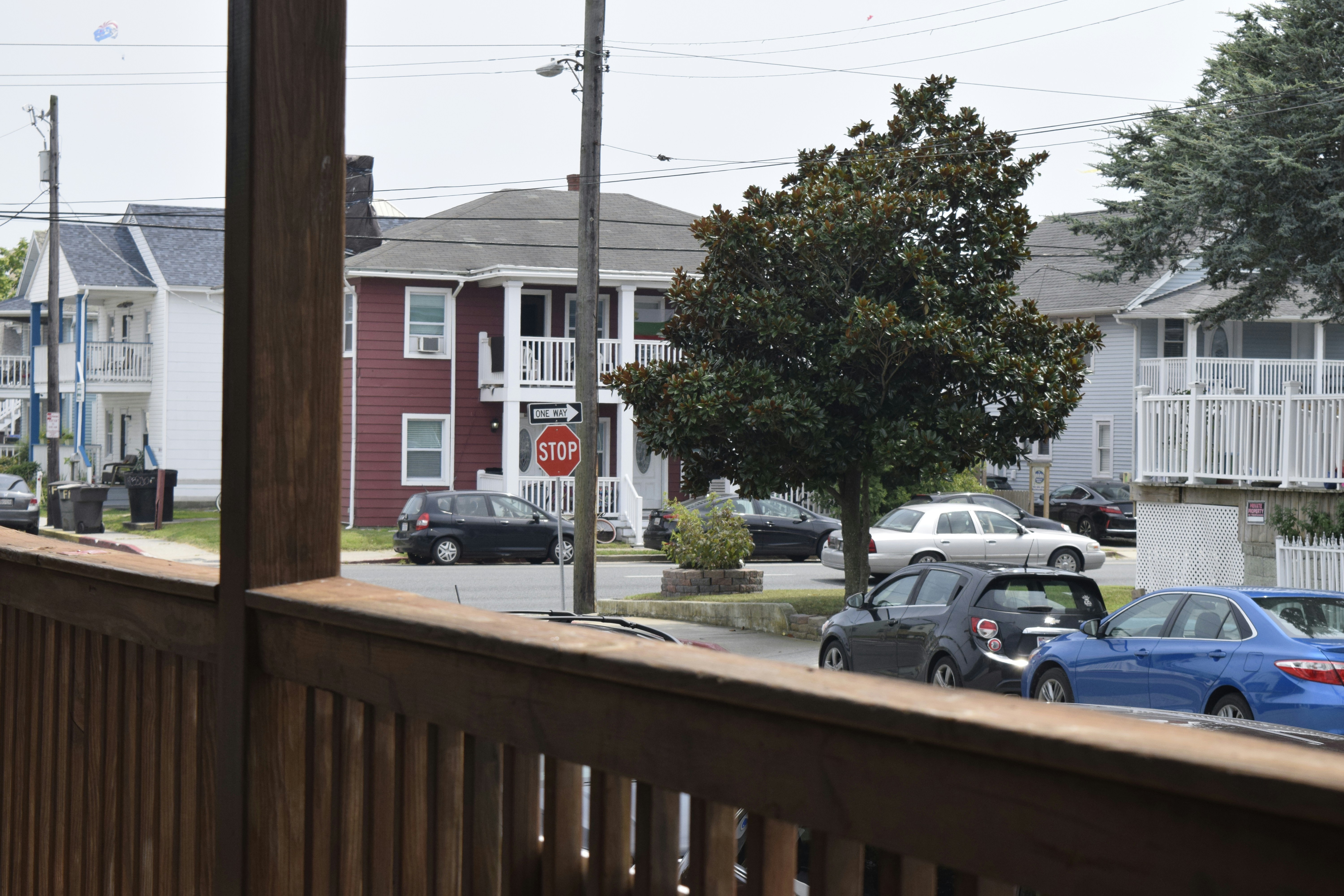 Cars Street View Of Houses And Cars From A Wooden Porch. 4K Wallpaper #2890