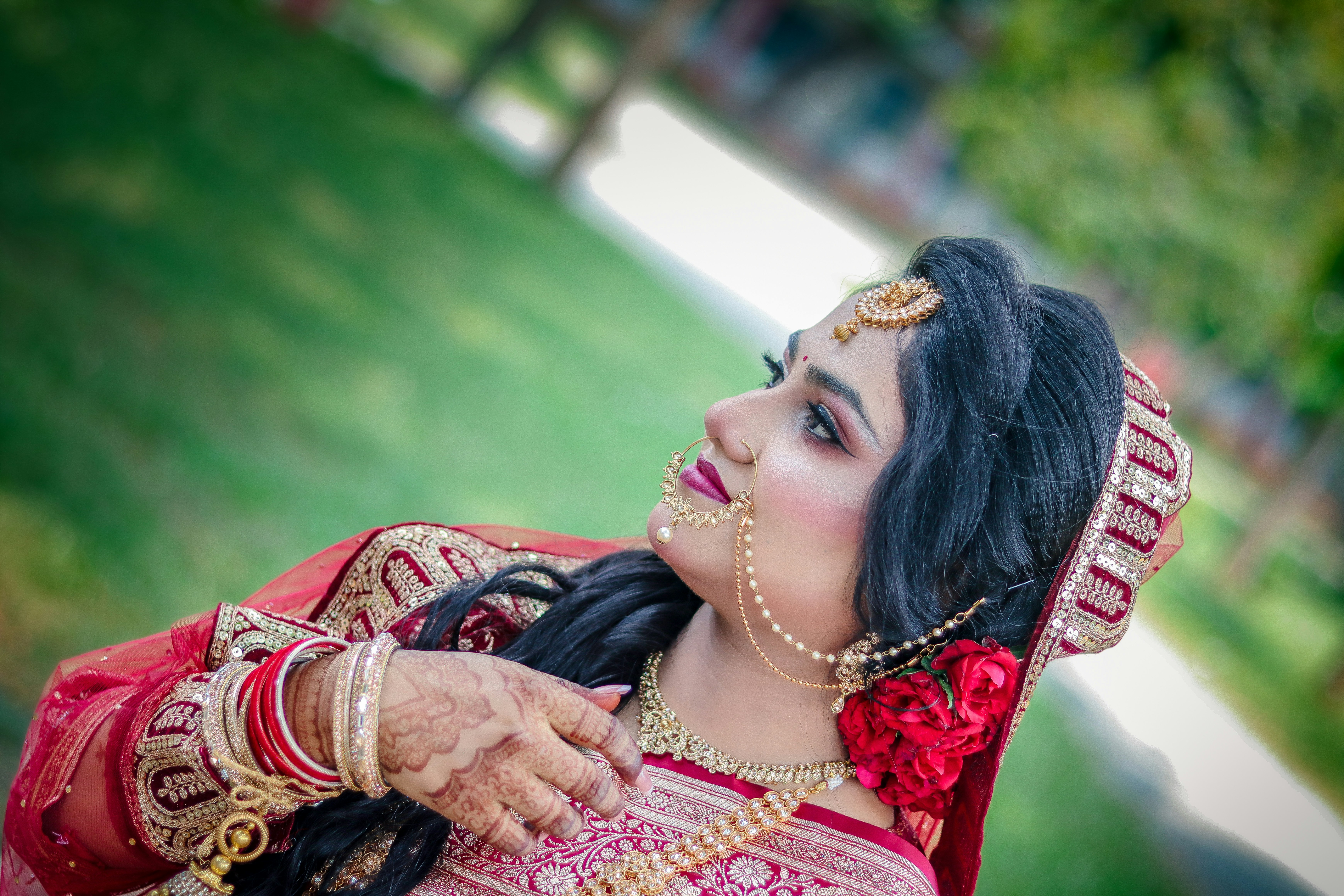 A beautiful indian bride in traditional red attire and jewelry.