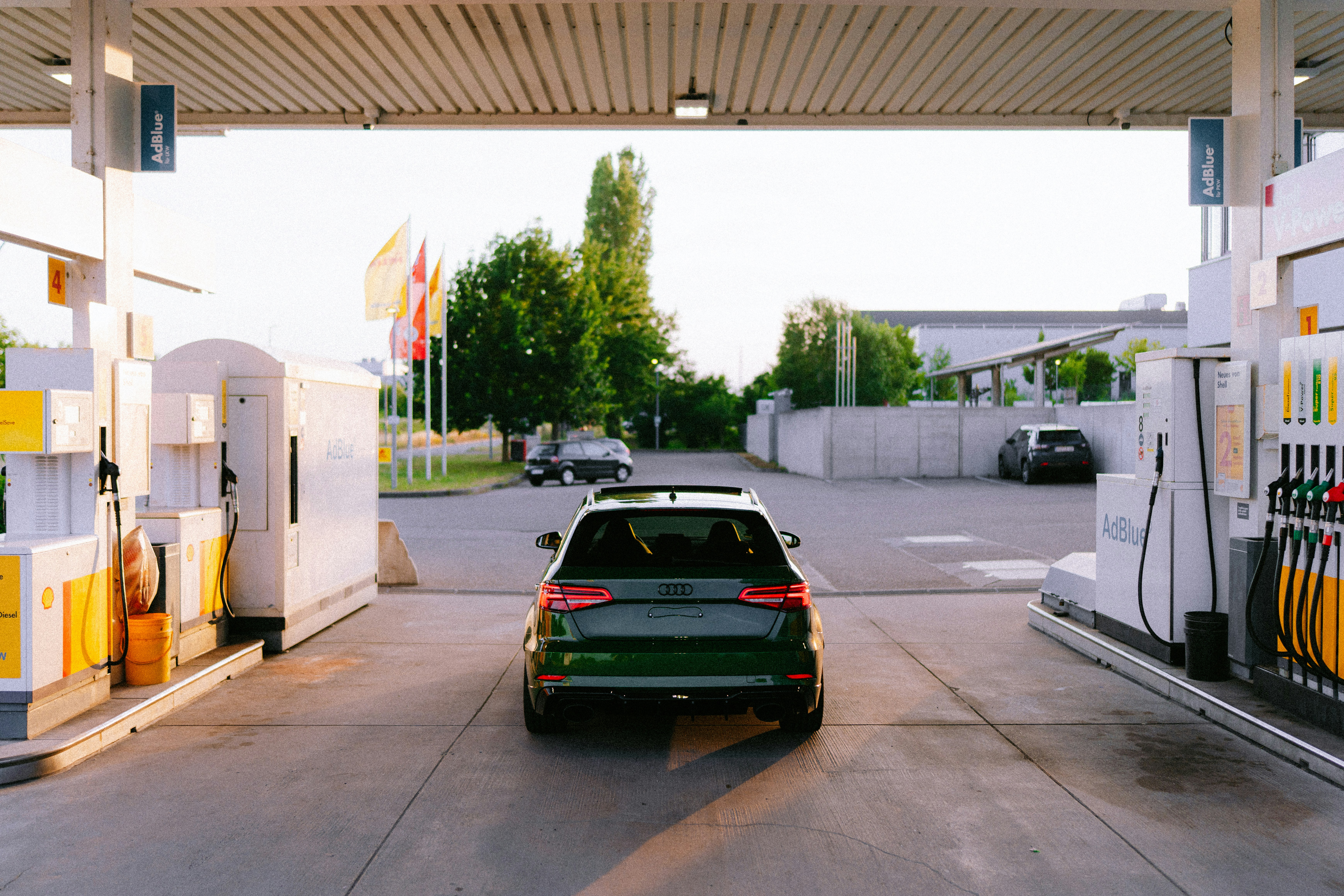 Cars A Green Car Parked At A Gas Station At Sunset. 4K Wallpaper #2894