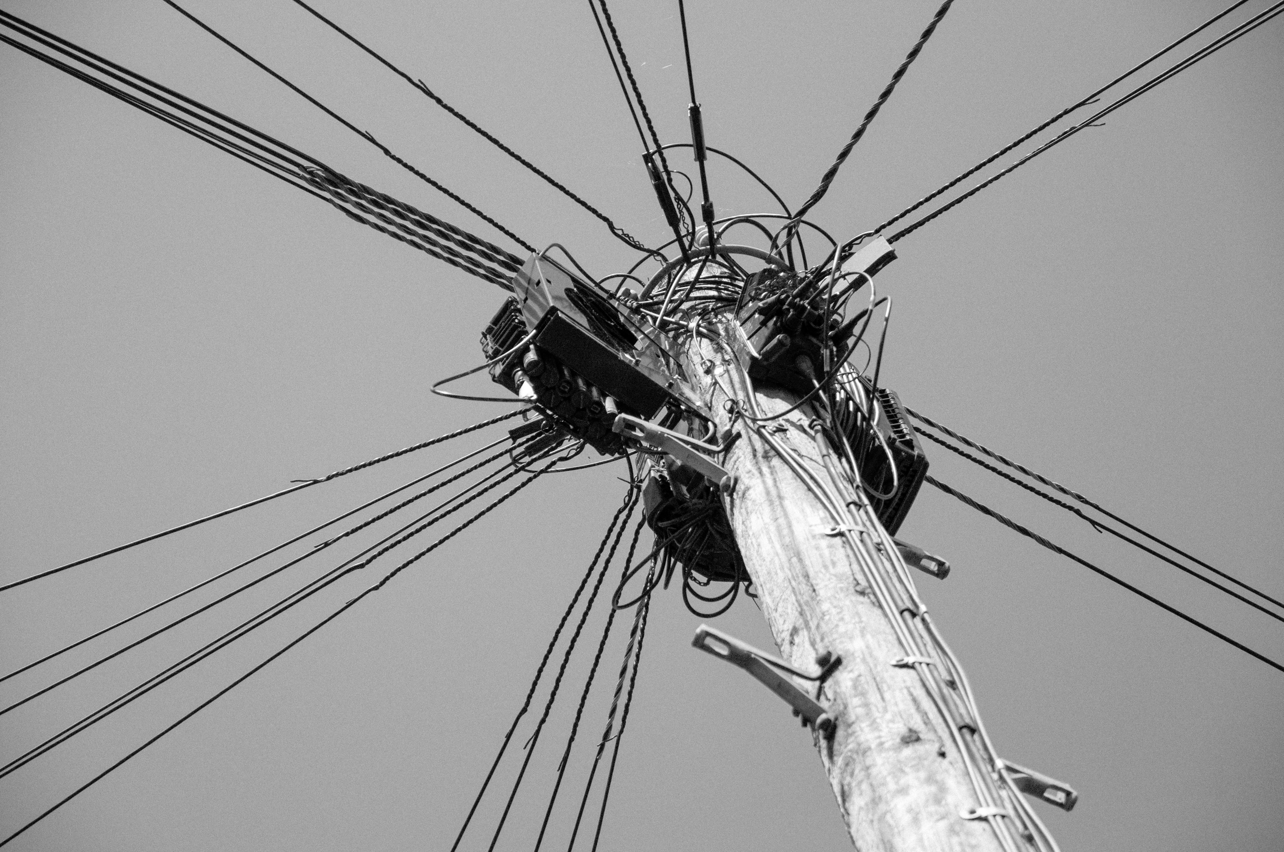 Technology Utility Pole With Tangled Wires Against A Plain Sky. 4K Wallpaper #2957