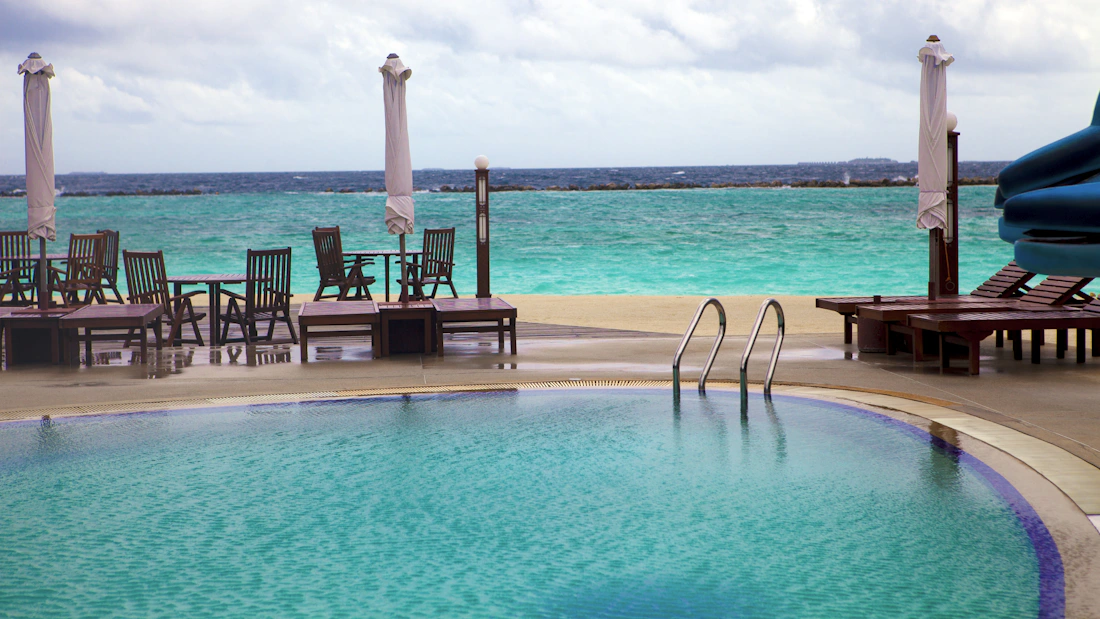 Maldives resort pool beside a turquoise ocean