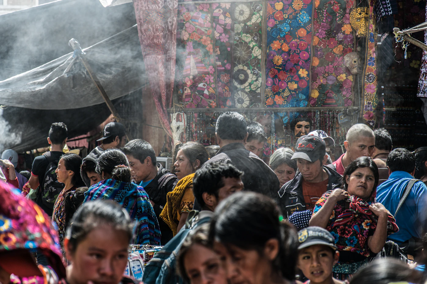 A crowded Latin American market with colorful textiles