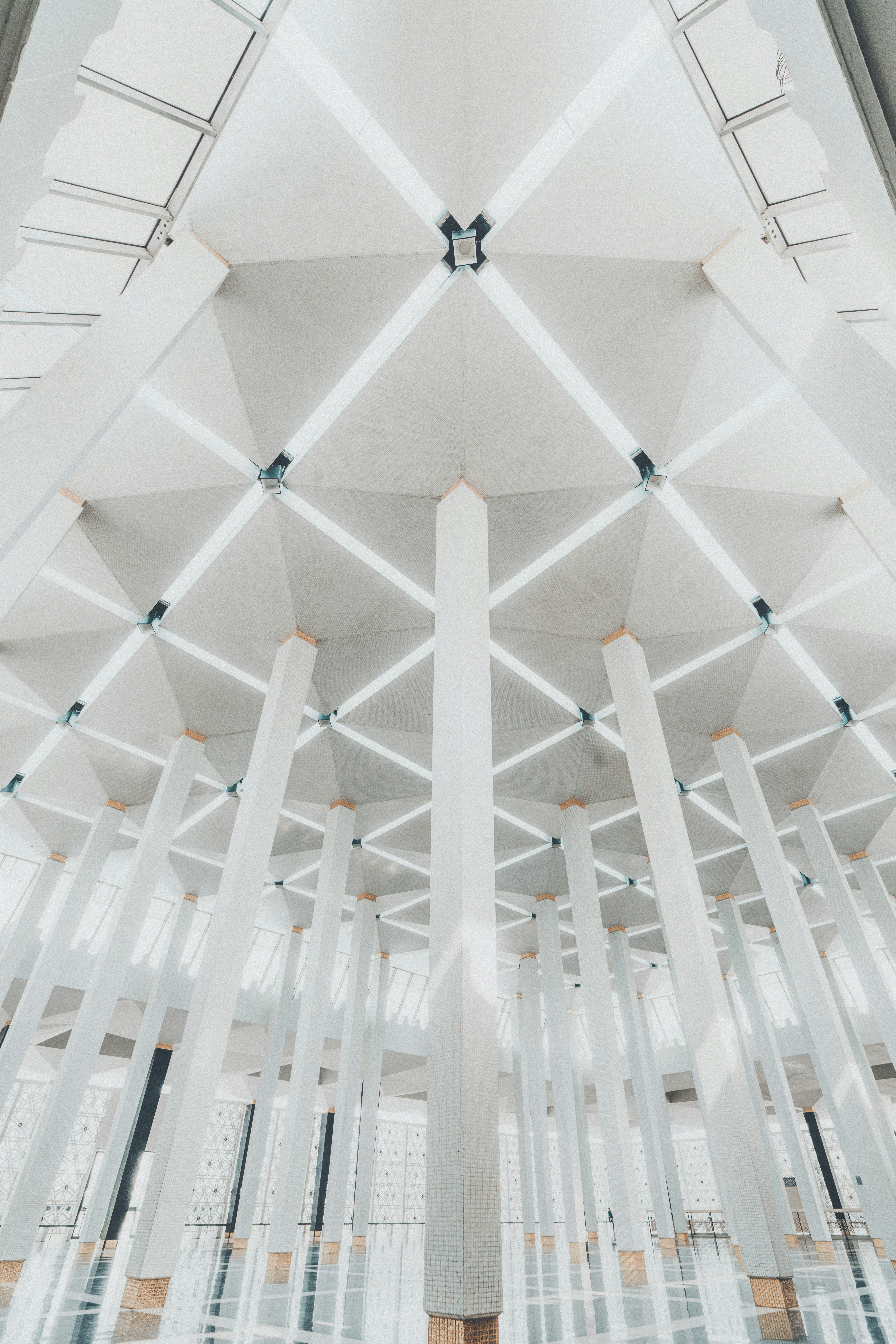 Modern architectural interior with geometric white ceiling and pillars