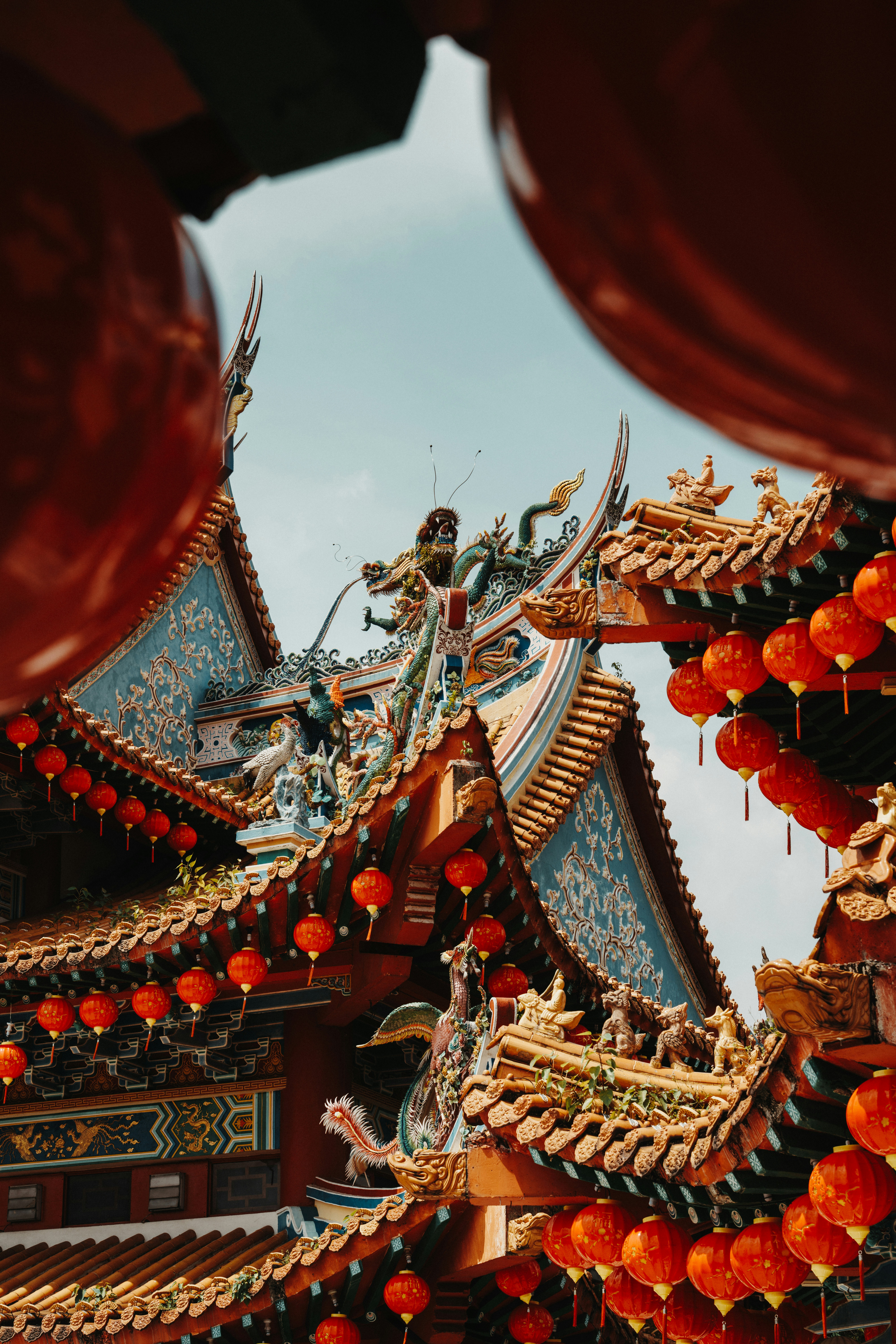 Intricate temple roof with vibrant red lanterns