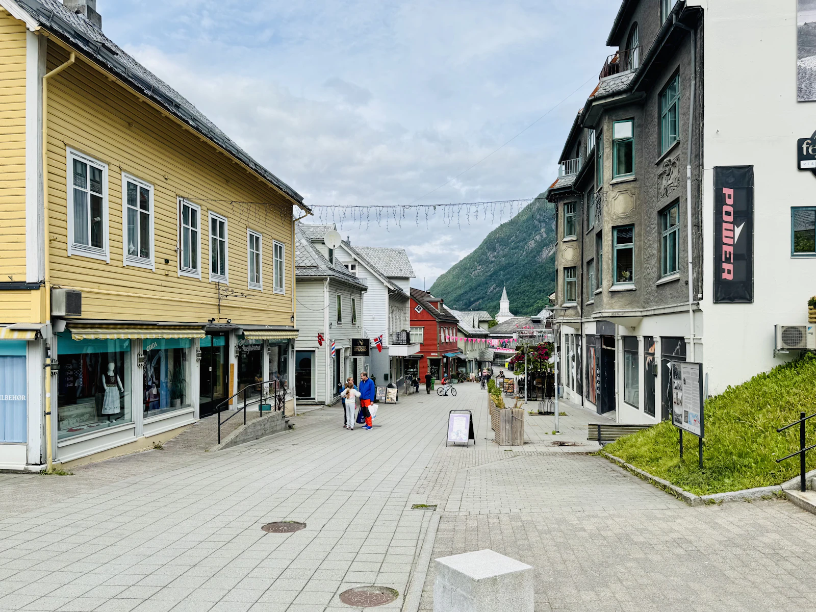 Pedestrian street lined with shops in a mountain town