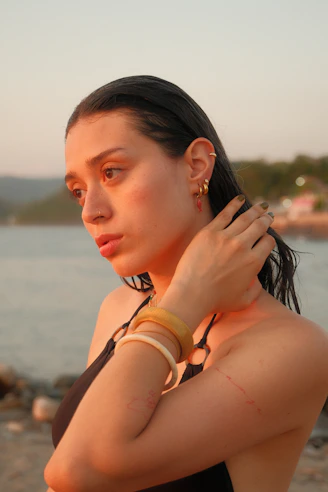 Young woman with wet hair by the sea at sunset.
