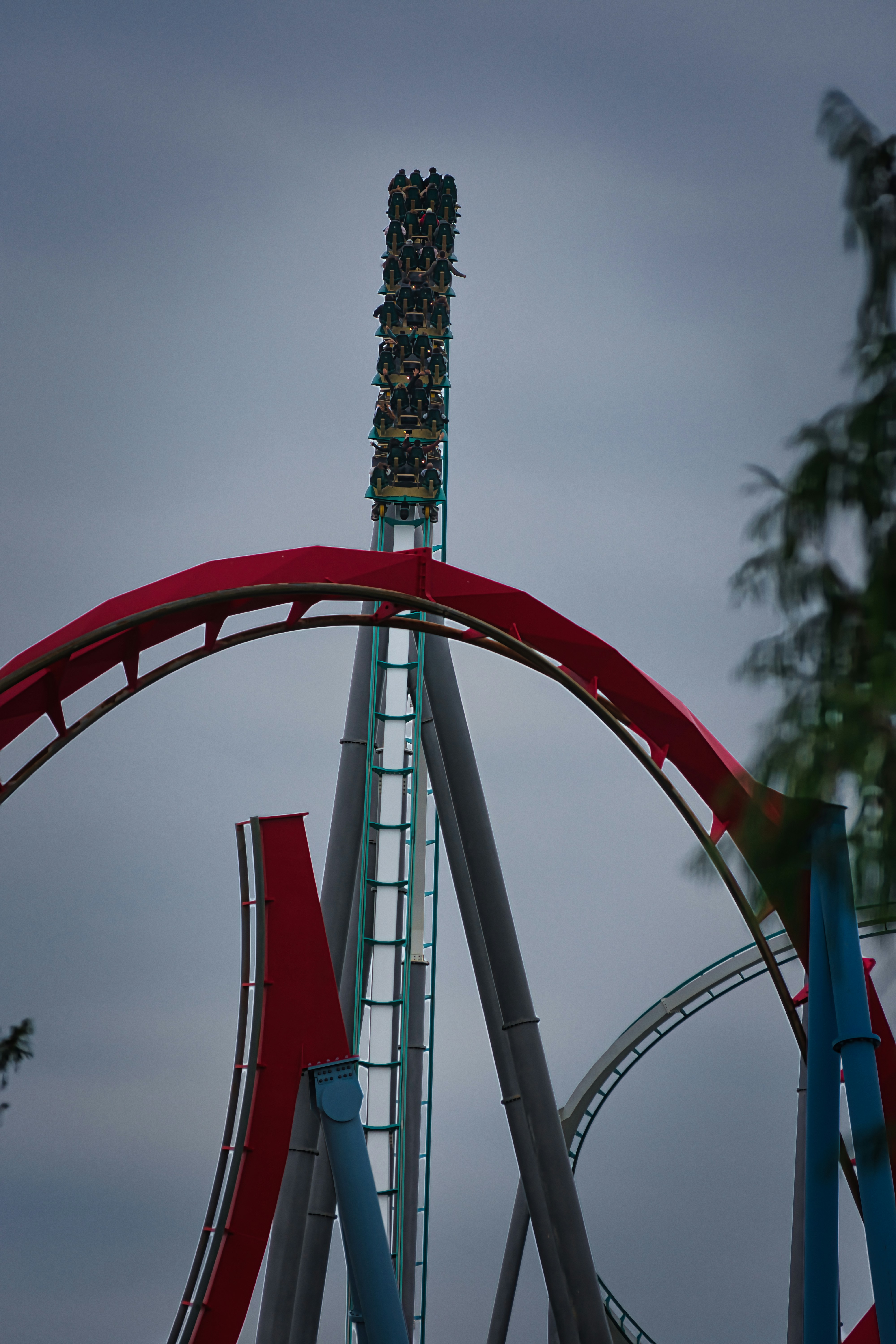 Roller coaster with riders on a steep ascent.