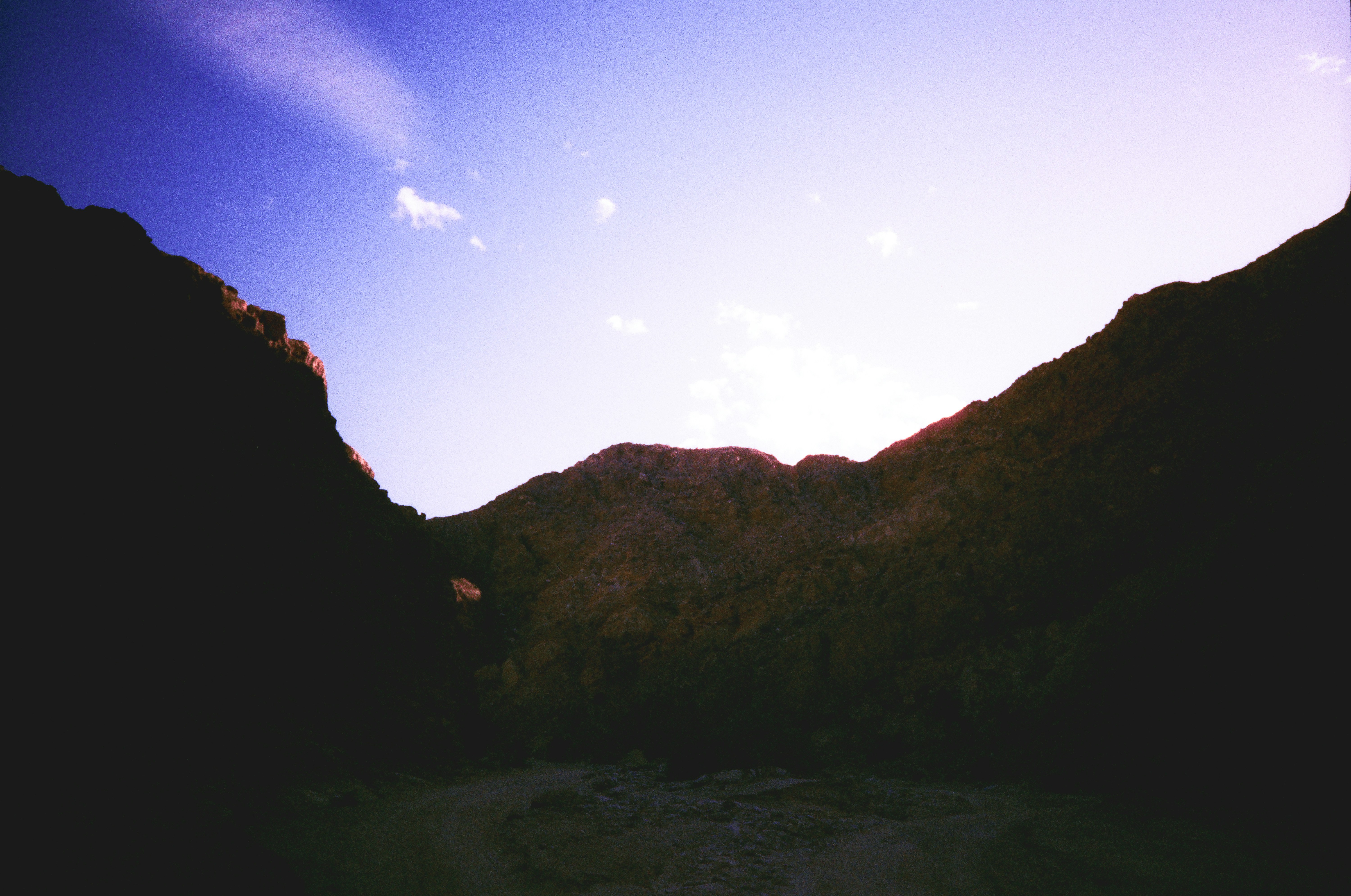 Dark mountain silhouettes against a vibrant sunrise sky.