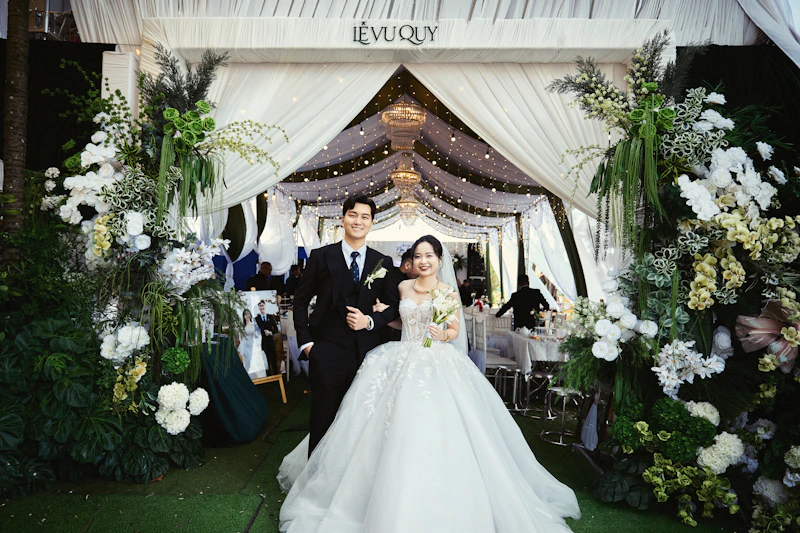 romantic couple walking through floral archway