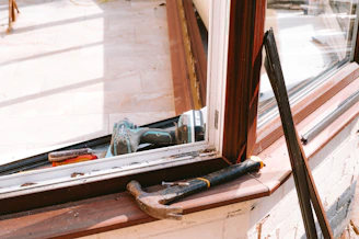 Hammer and drill on window sill during repair