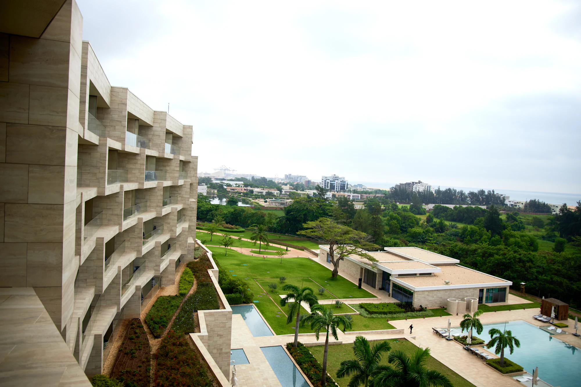 Contemporary resort architecture above landscaped grounds and pool