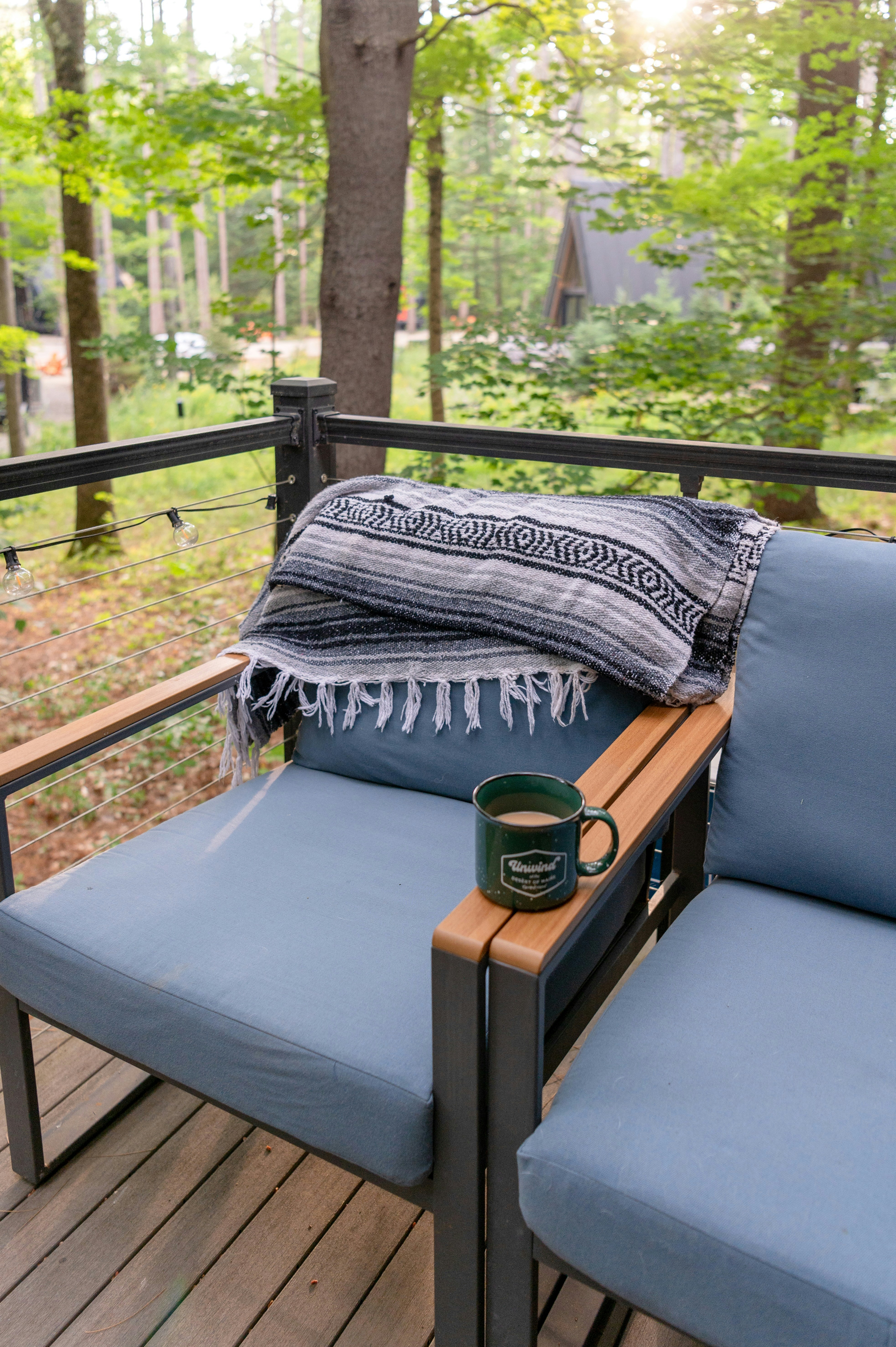 Outdoor patio deck glamping chairs with blanket and mug