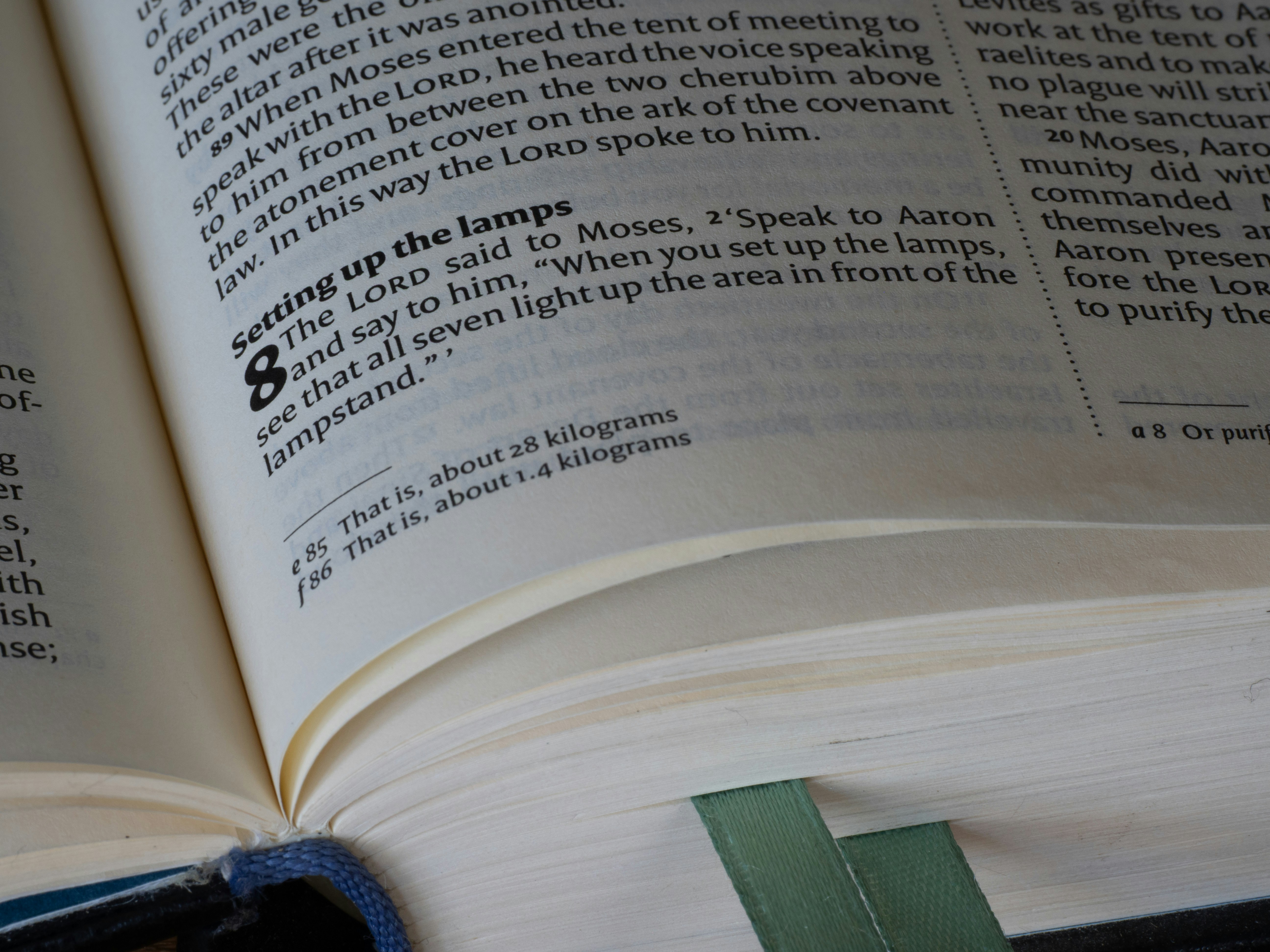 An open book with visible text and a green bookmark.