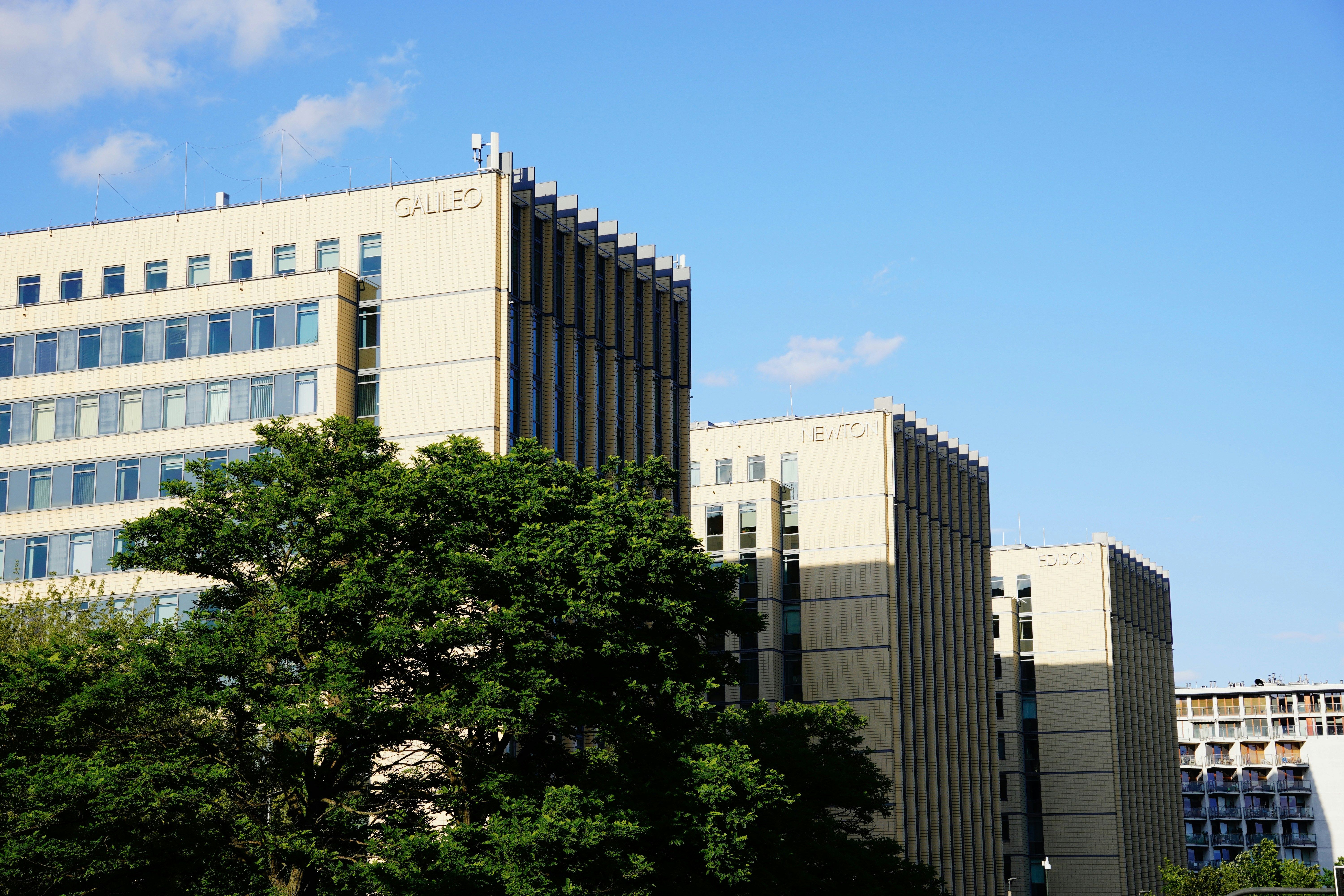 Tall buildings of ummc complex against a clear blue sky.