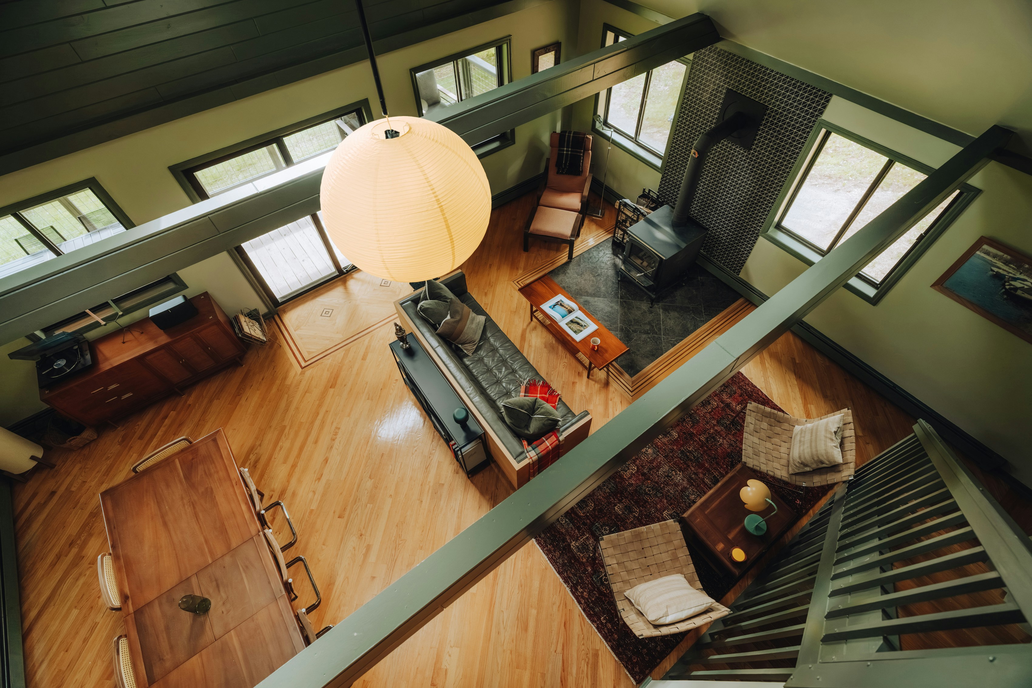 Photo of Bright open-plan interior with wood floors and high ceiling by Clay Banks