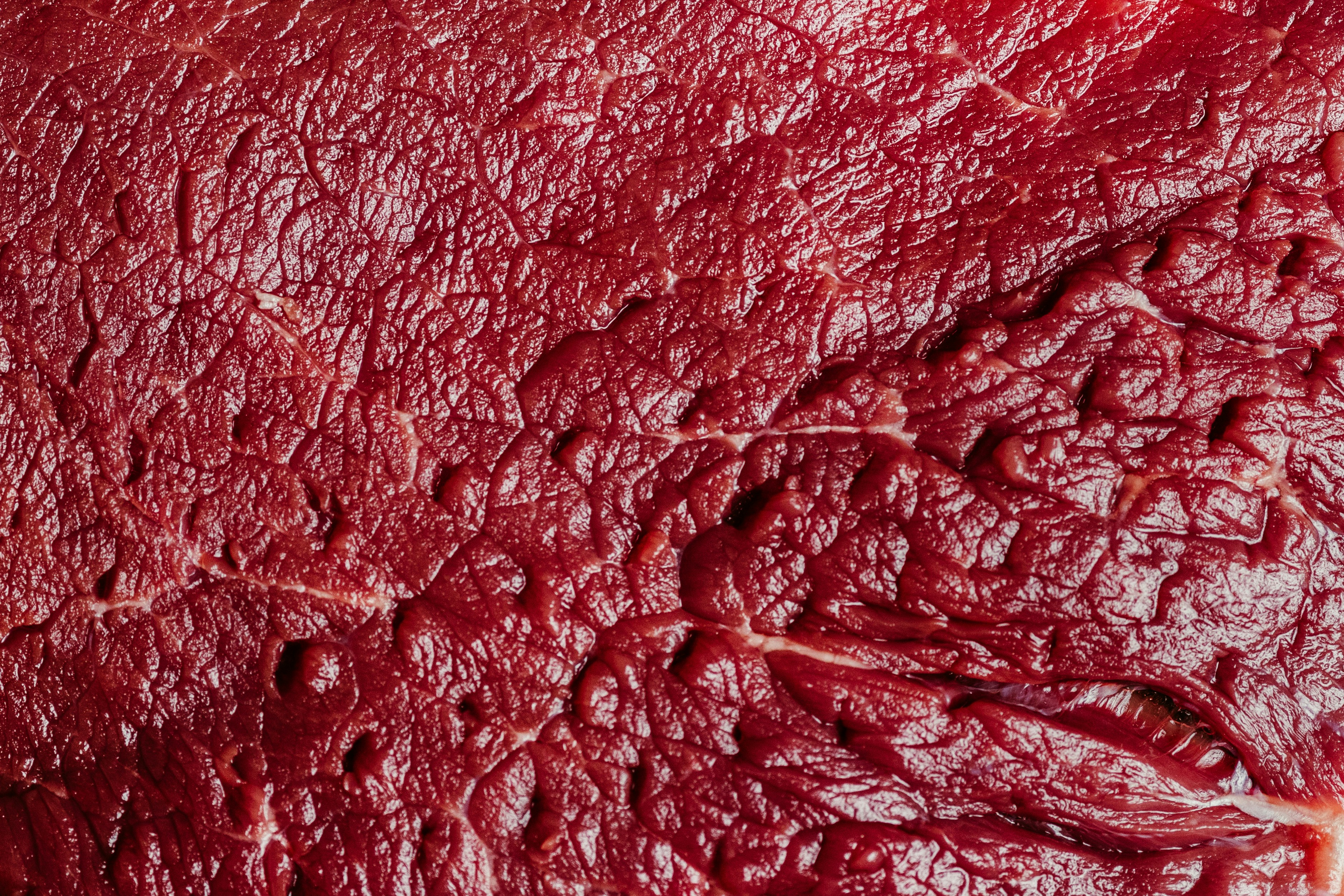Close-up texture of raw red meat surface