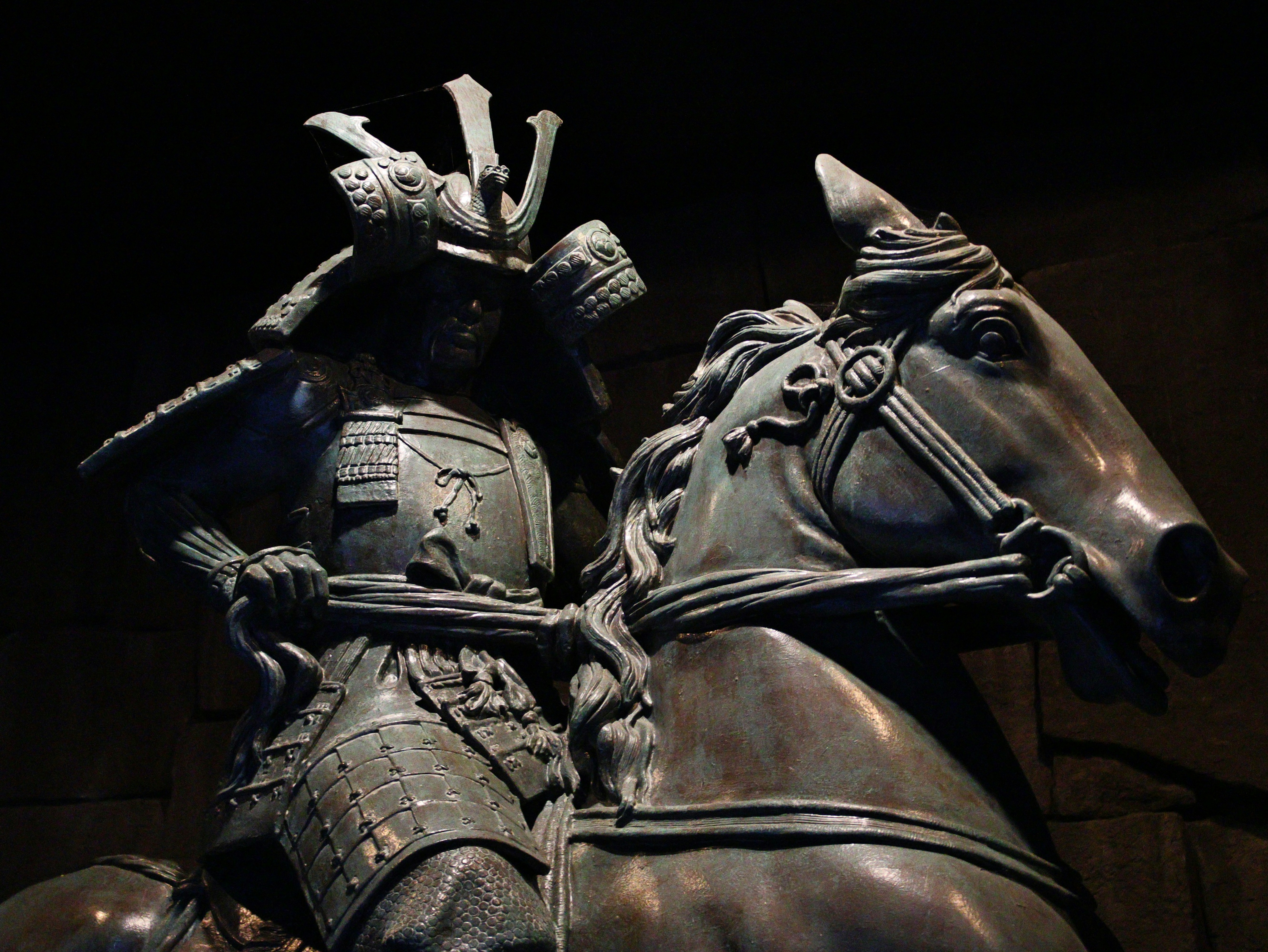 A bronze statue of a samurai warrior on horseback.