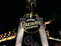 Toothsome chocolate emporium building with smokestacks at night