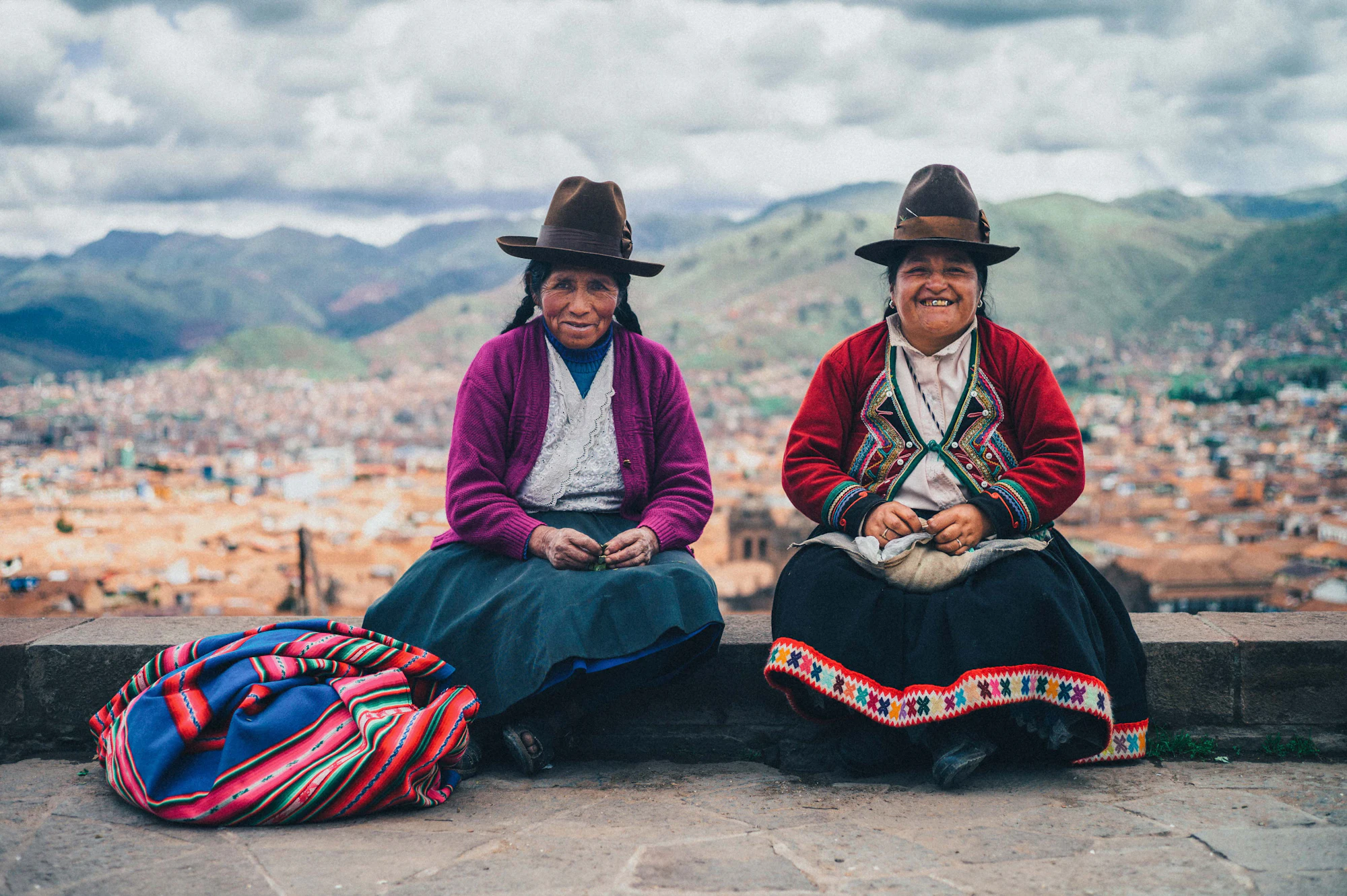 Dos mujeres quechuas miran la ciudad desde la montaña