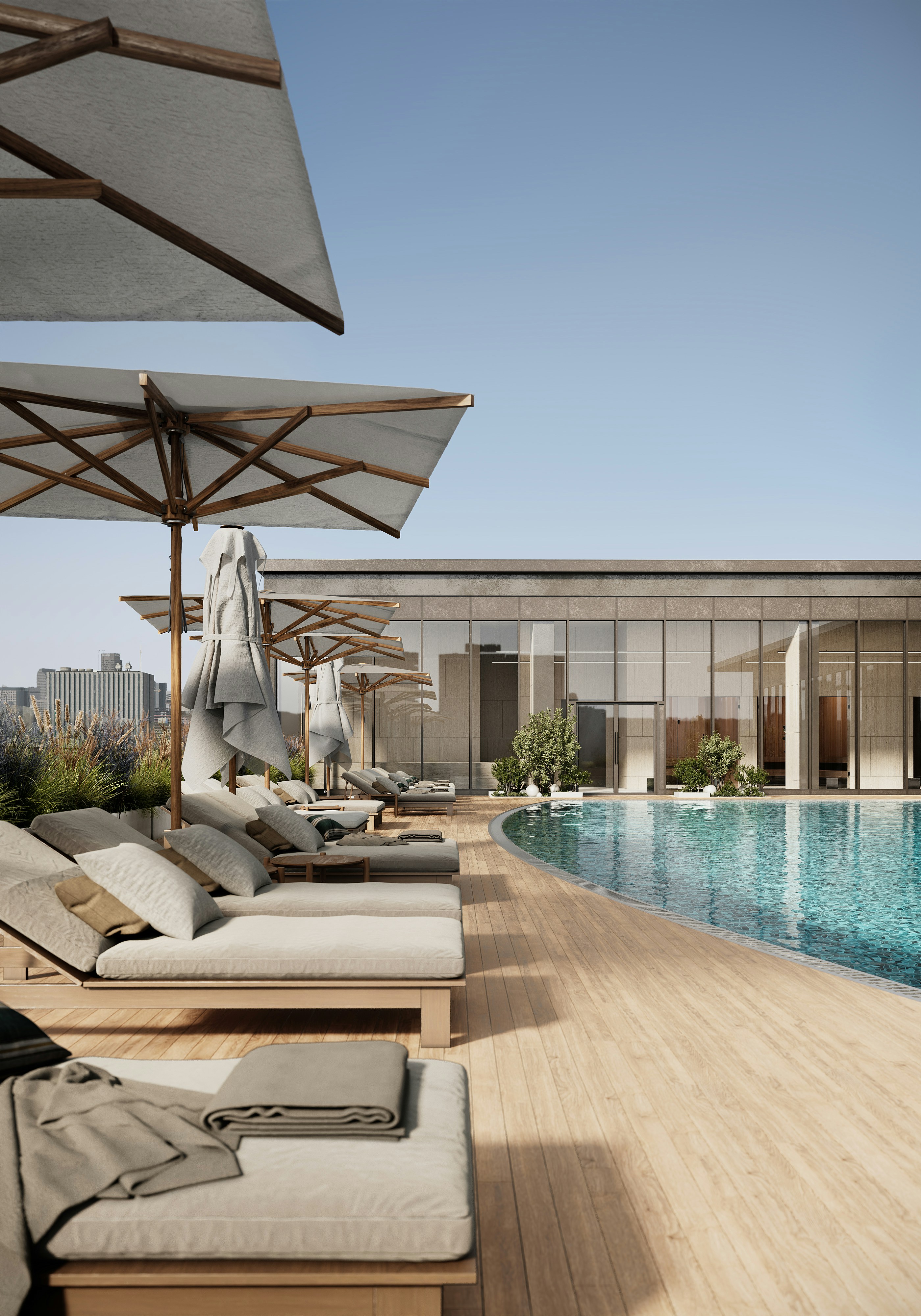 Serene rooftop pool area with lounge chairs and umbrellas.