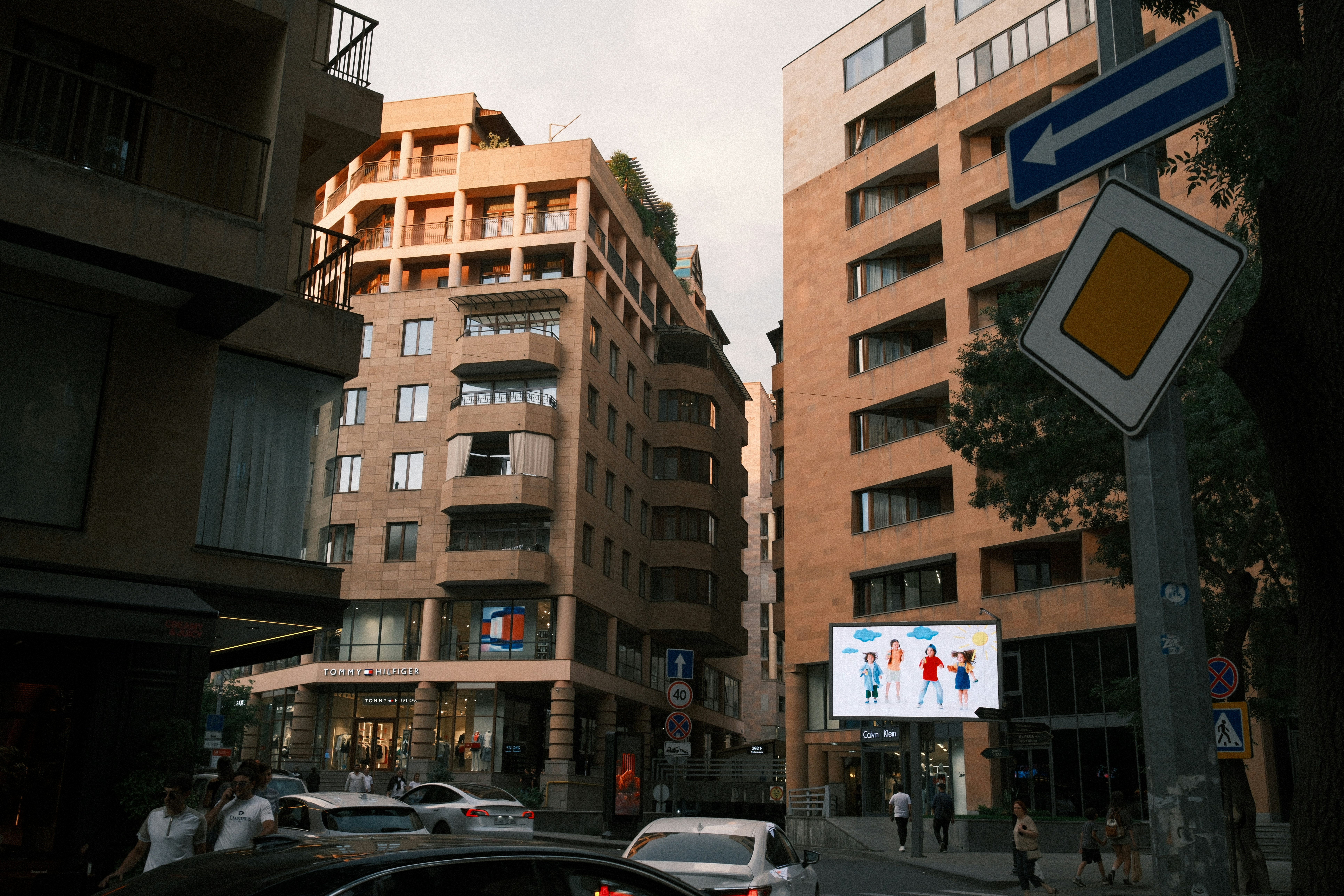 advertising billboard city street - City street with modern buildings, cars, and a digital billboard.