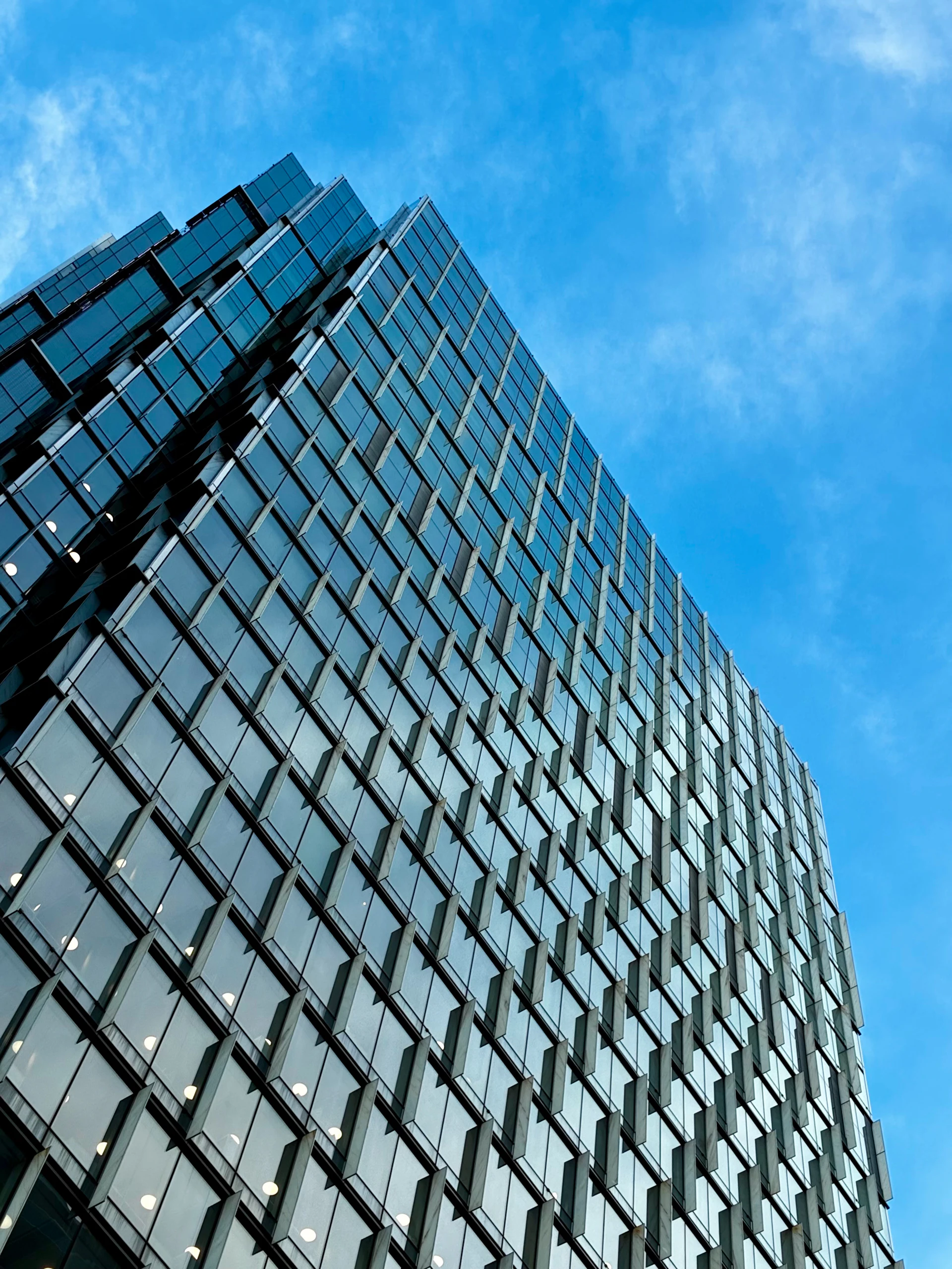 Modern glass commercial skyscraper against a clear sky
