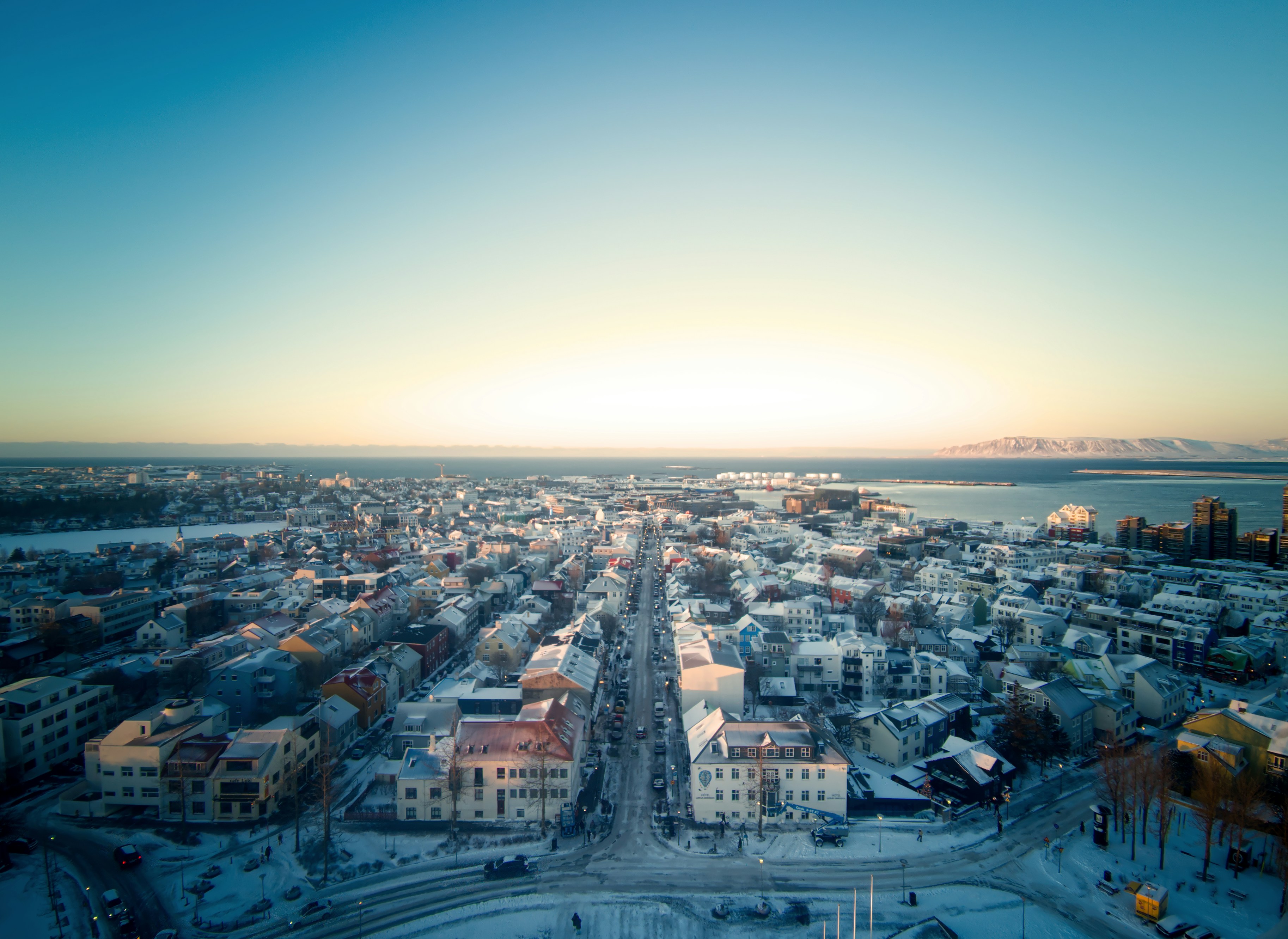 Aerial view of a snow-covered city at sunrise.