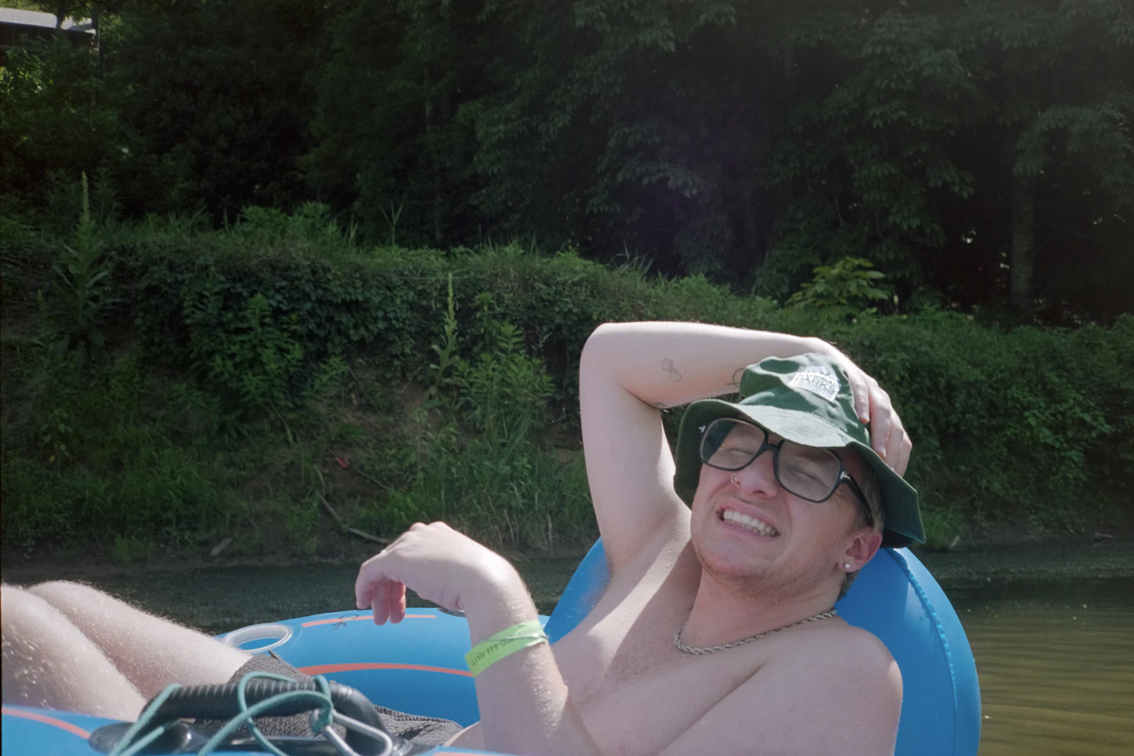 A smiling floater drifting down Salt Creek on a sunny afternoon