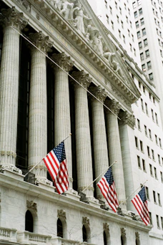 American flags adorn a classical building with imposing columns