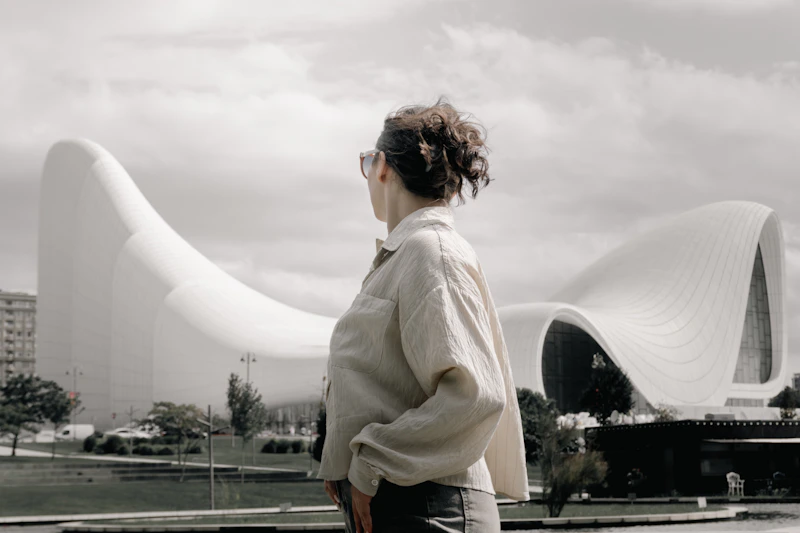 person admiring a modern white wavy building