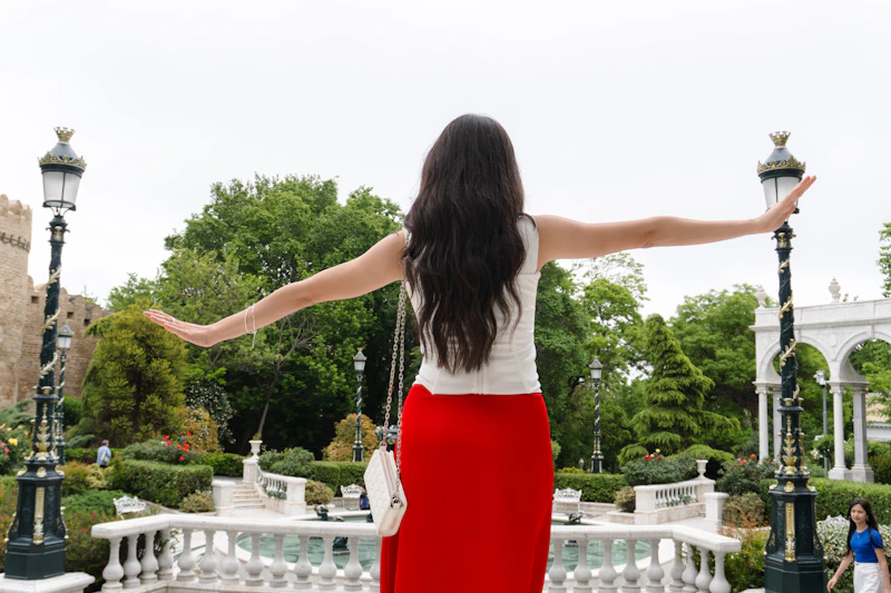 woman in red skirt embracing a garden moment