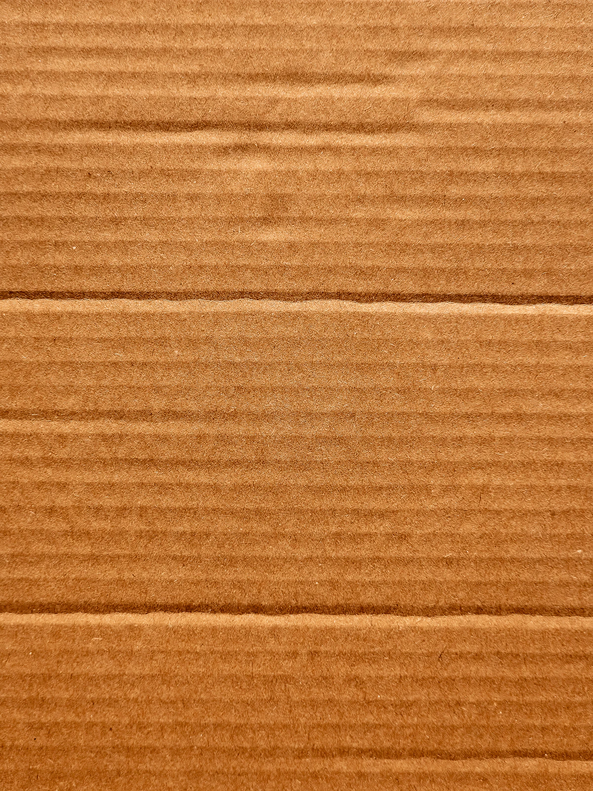Pallets of corrugated export boxes of various sizes stacked in a warehouse ready for sea freight