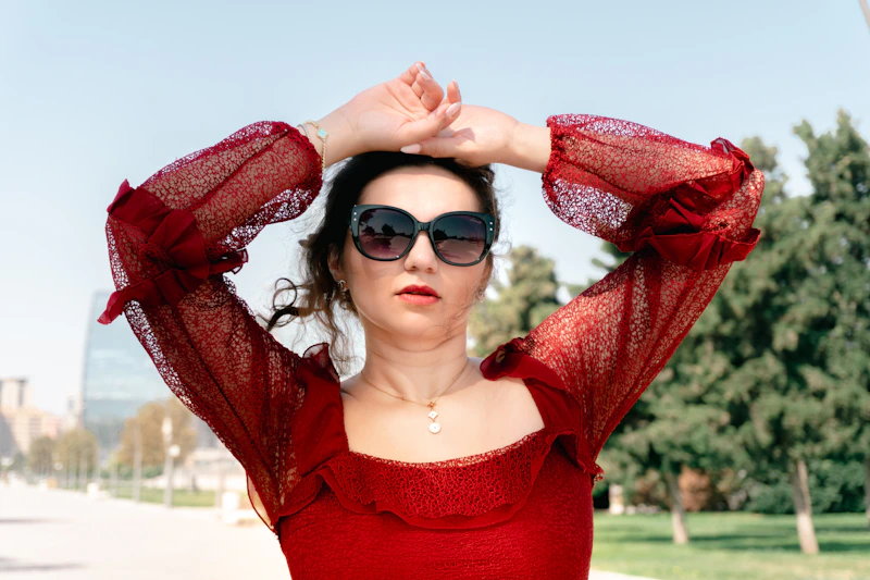 confident woman in red top and sunglasses