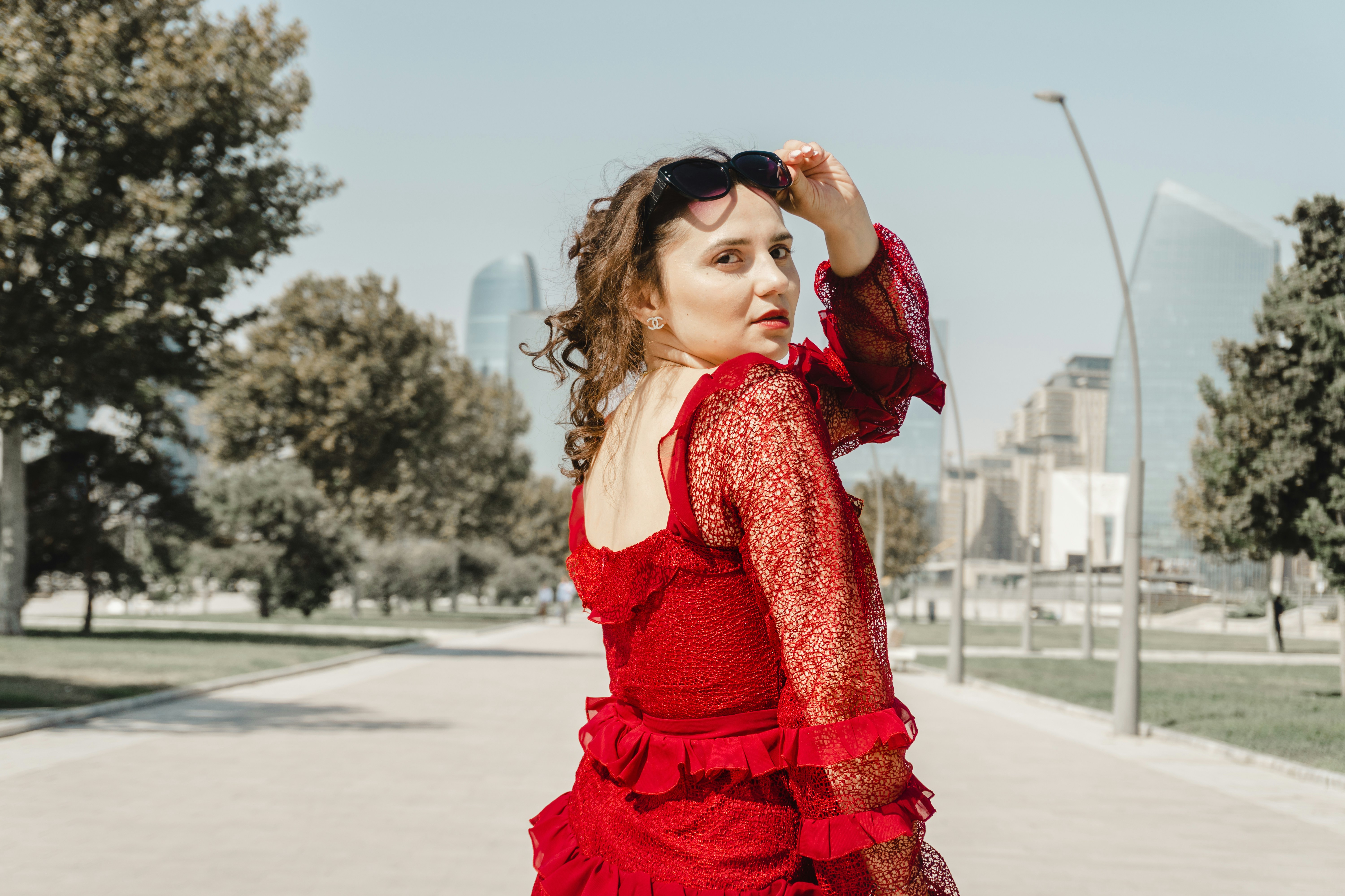 A collection of cherry red accessories including a handbag, scarf, and shoes