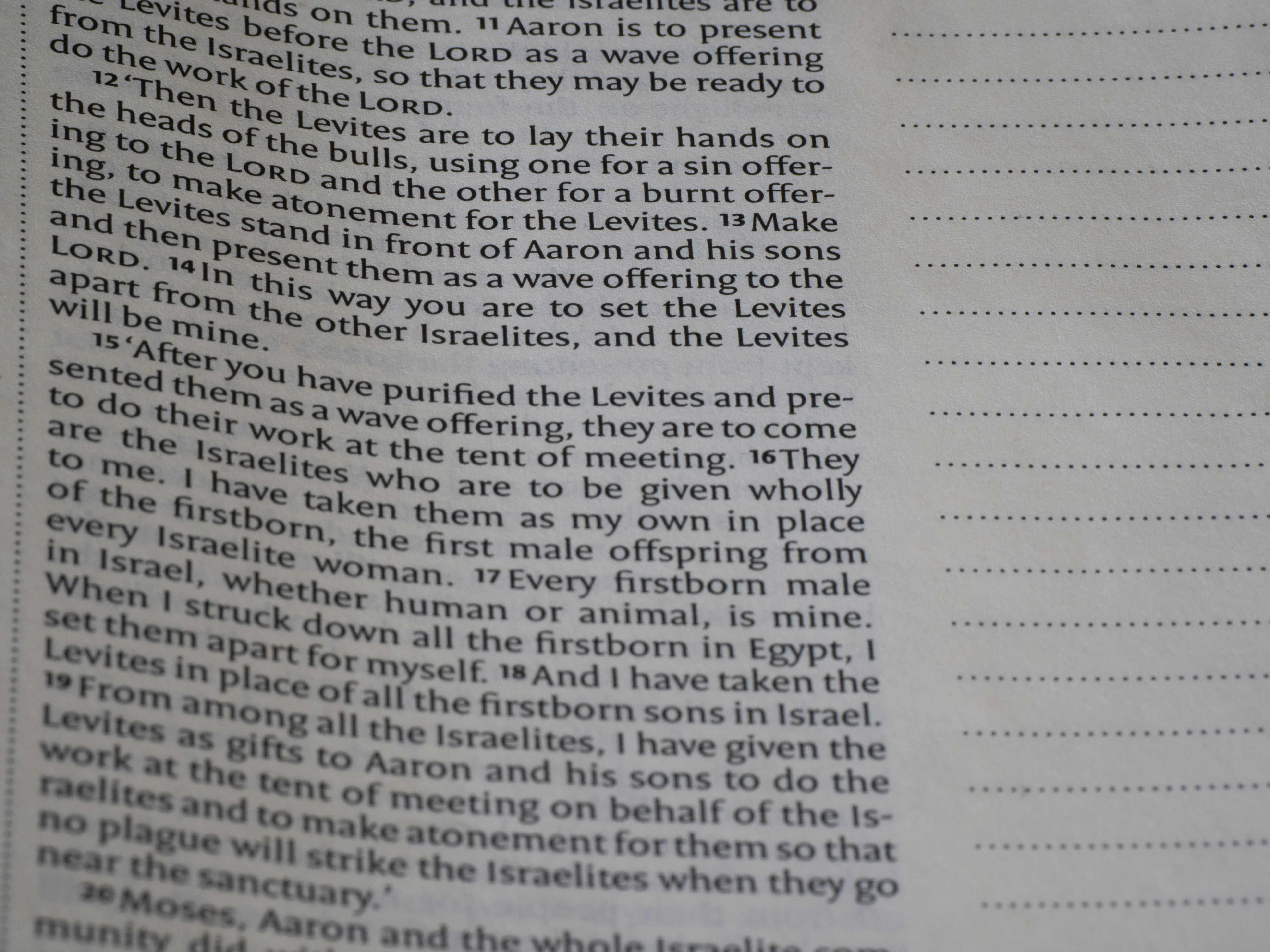 Bible page with text on left, blank lines on right.