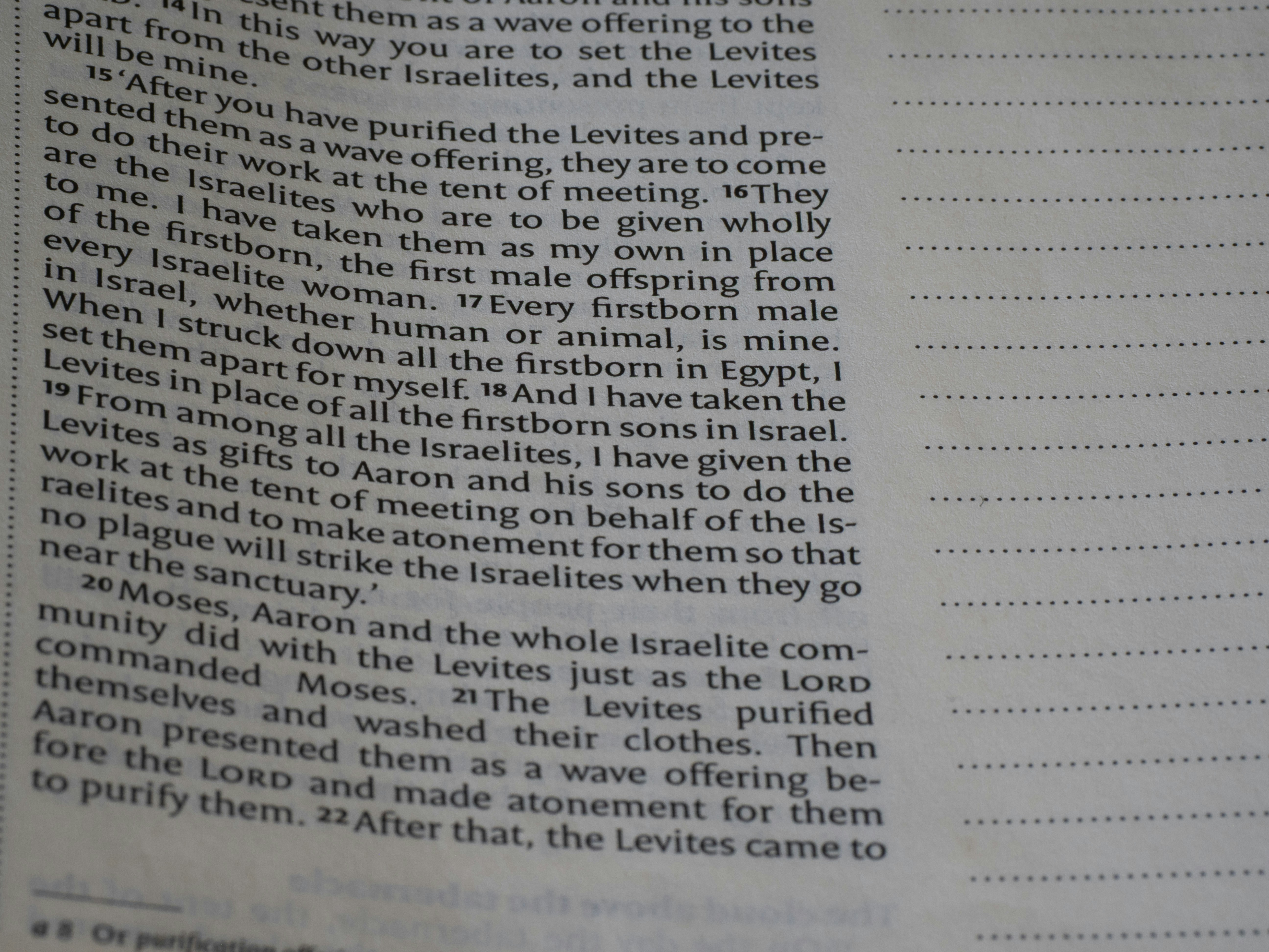 Bible text on a page with blank ruled lines.