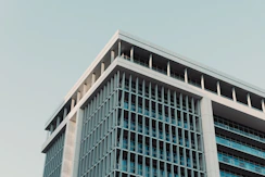 Modern building with geometric lines against a clear sky.