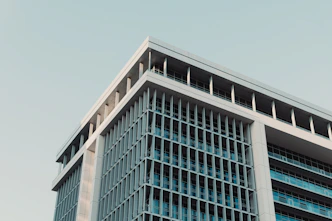 Modern building with geometric lines against a clear sky.