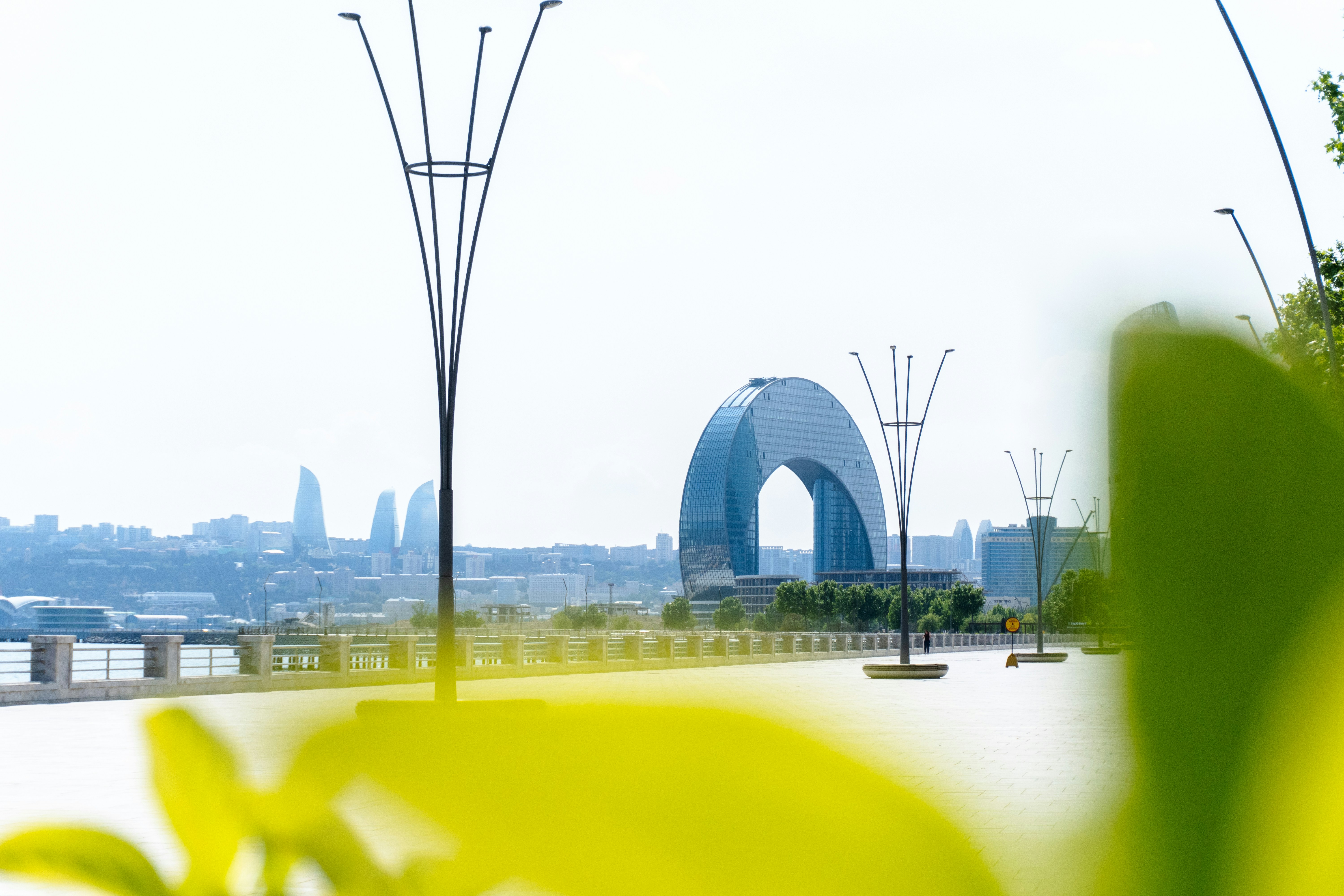 City A Modern Arch Shaped Building Overlooks A City Skyline With Streetlights. 4K Wallpaper #3544