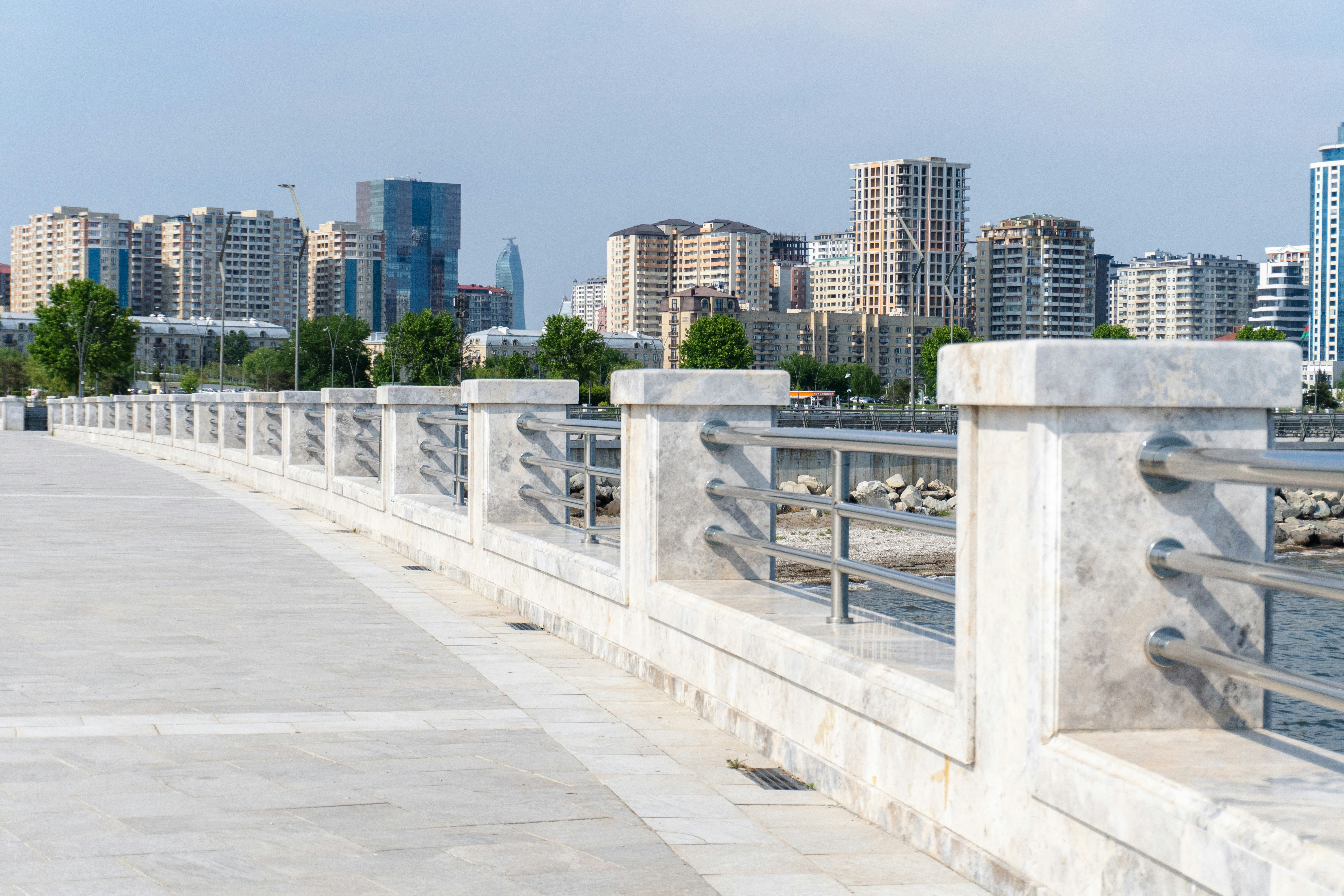 City A Promenade With A Stone Railing Overlooking A Modern Cityscape. 4K Wallpaper #3546
