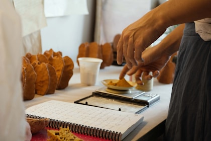 Hands weighing ingredients on a kitchen scale