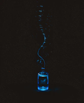 Glowing blue liquid in a bottle with an ascending stream
