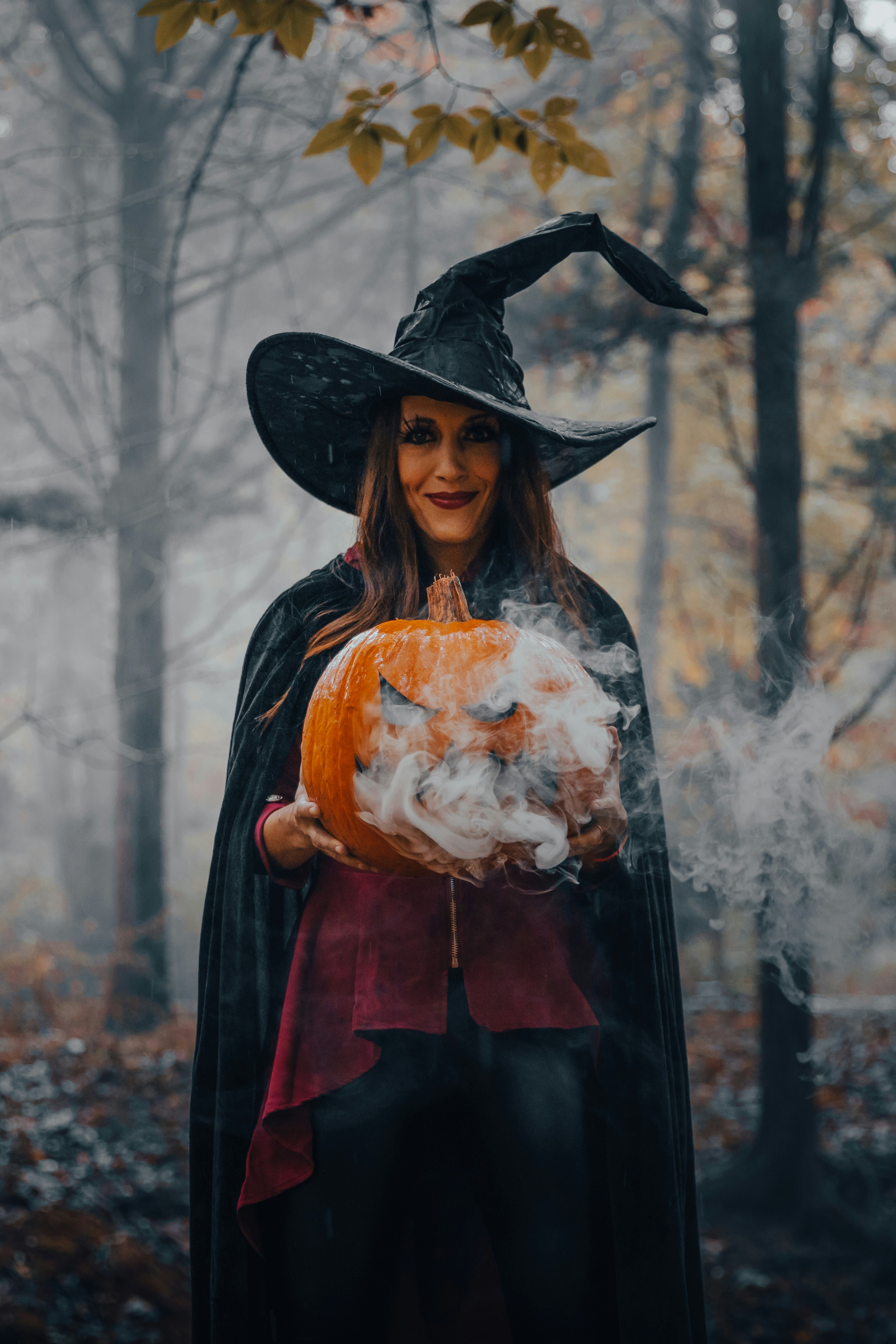 Foggy midnight forest with glowing pumpkin